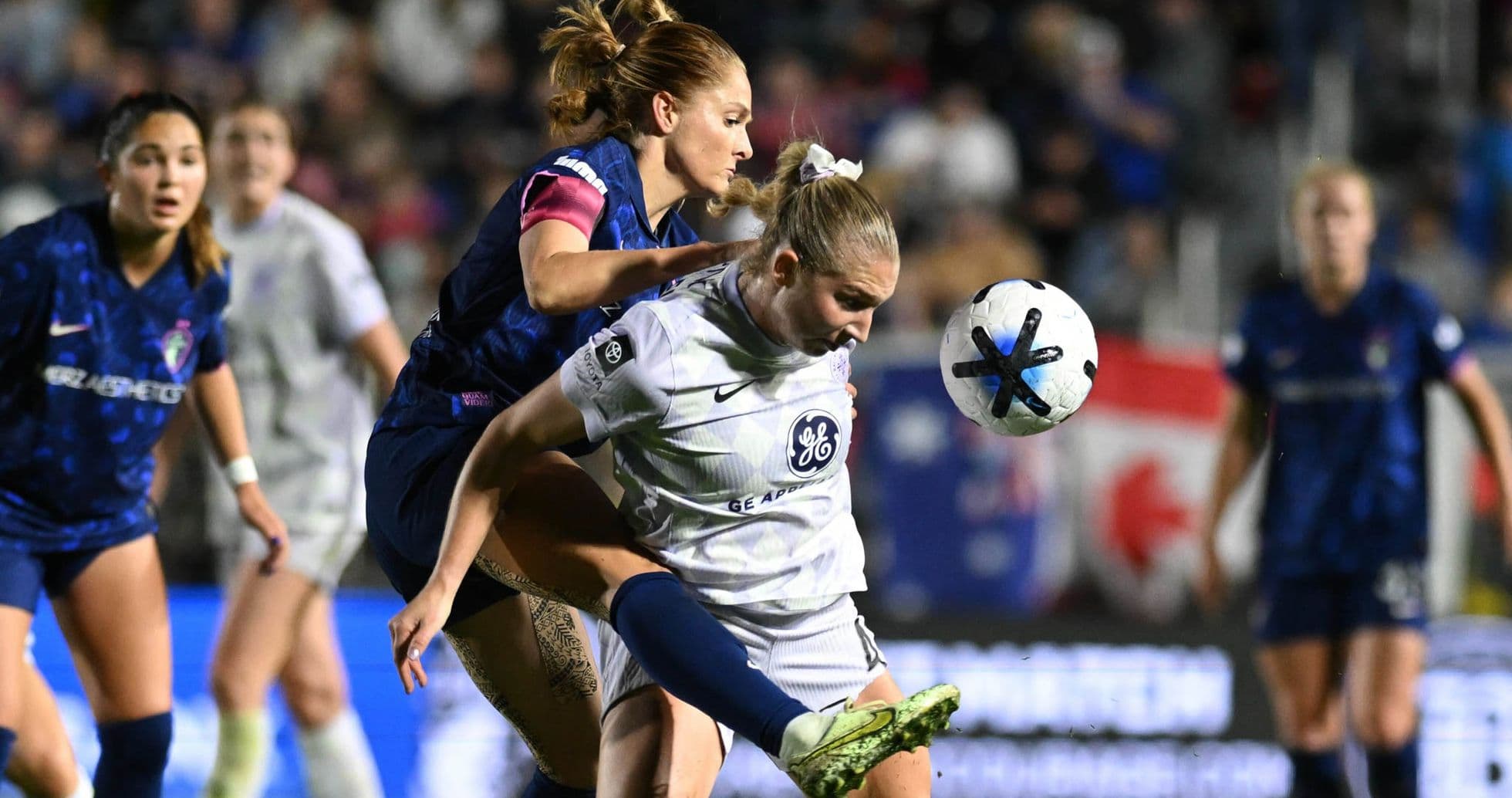 Player competing for the ball in NWSL match Player competing for the ball in NWSL match