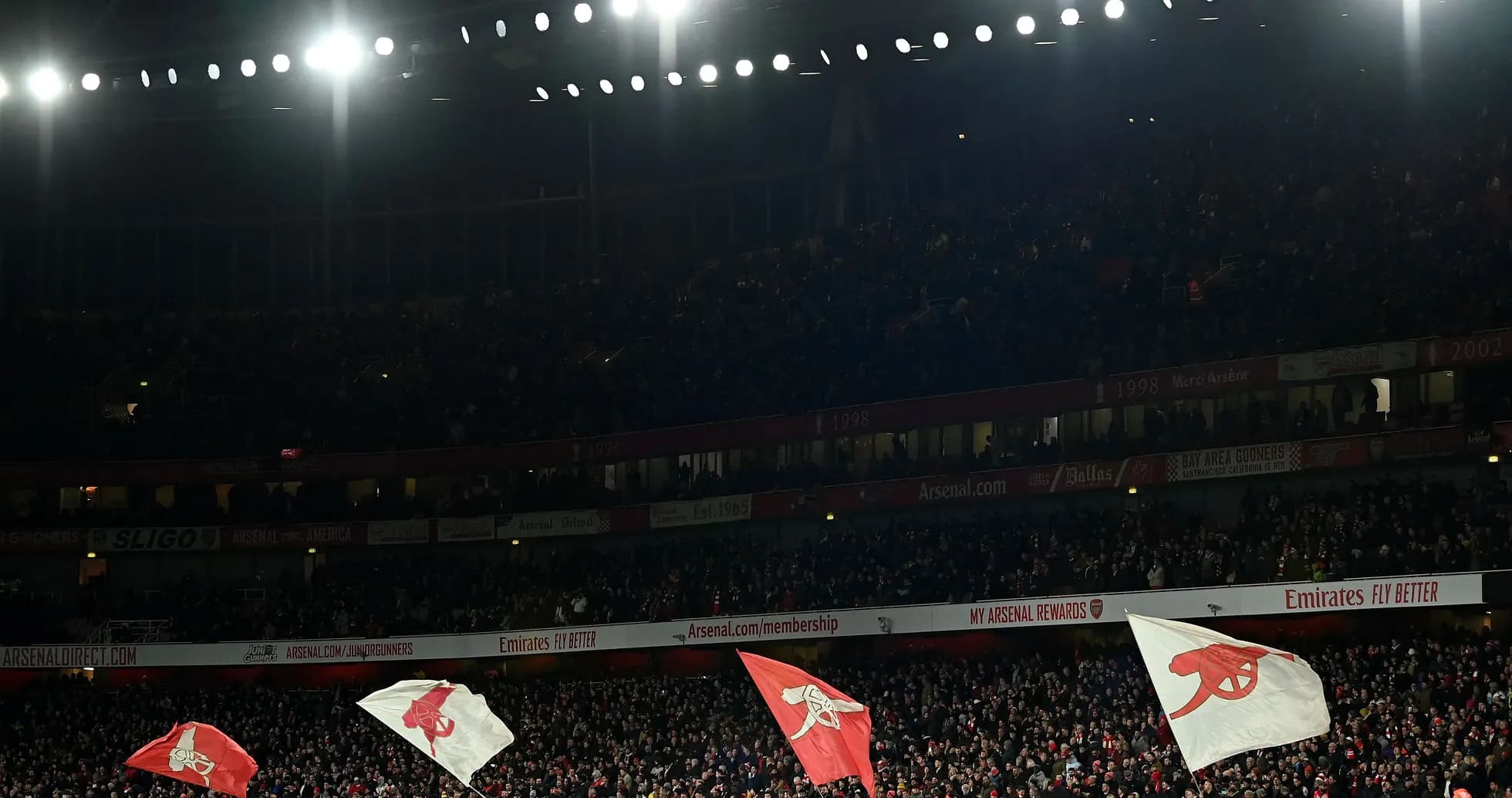 Fans waving Arsenal flags in packed stadium Fans waving Arsenal flags in packed stadium