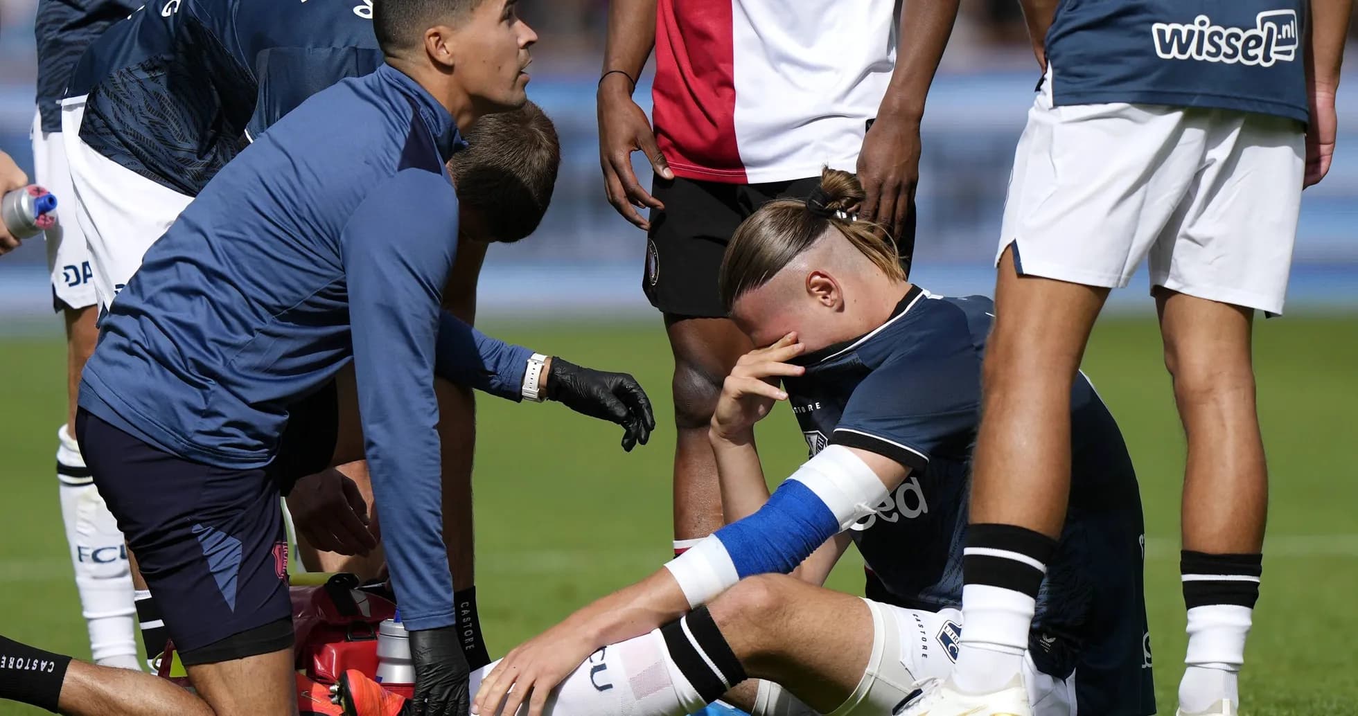 Player receiving medical attention on the field Player receiving medical attention on the field