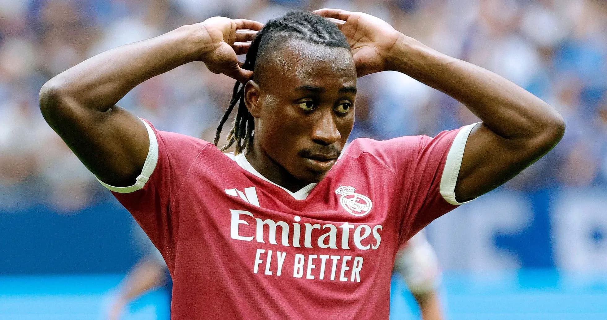 Player adjusting hair during football match Player adjusting hair during football match