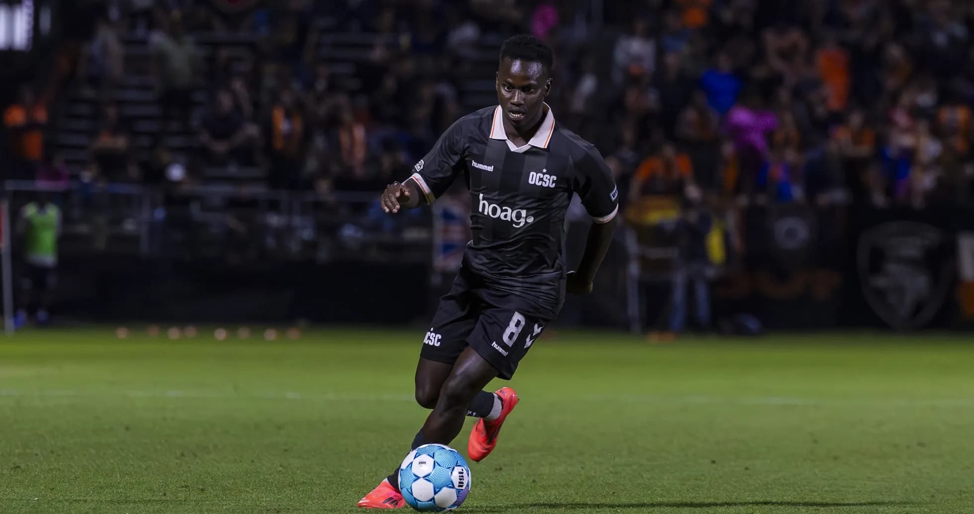Orange County SC player dribbling the ball Orange County SC player dribbling the ball