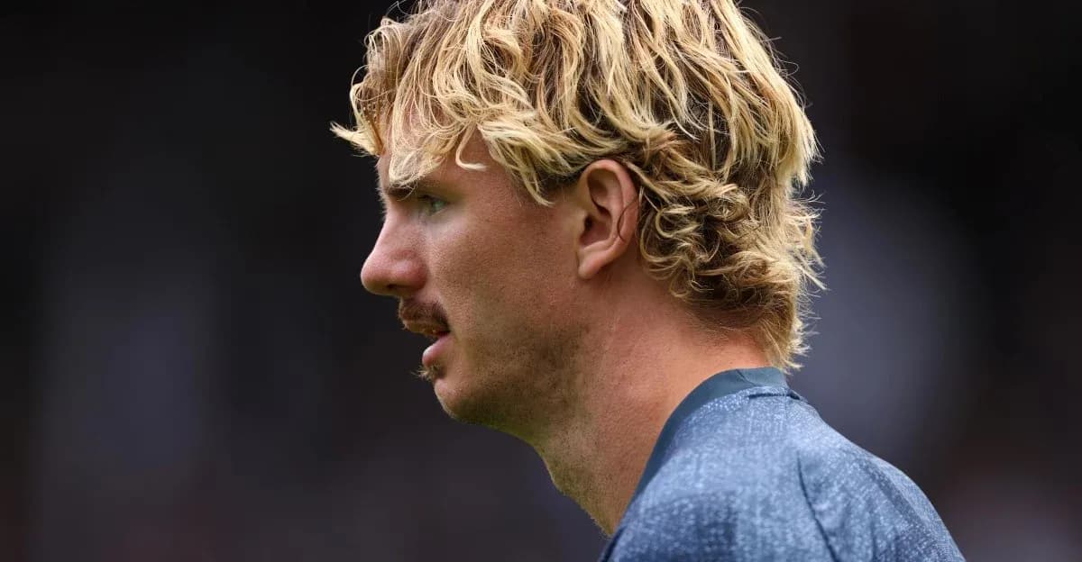 Player in profile with curly blonde hair Player in profile with curly blonde hair
