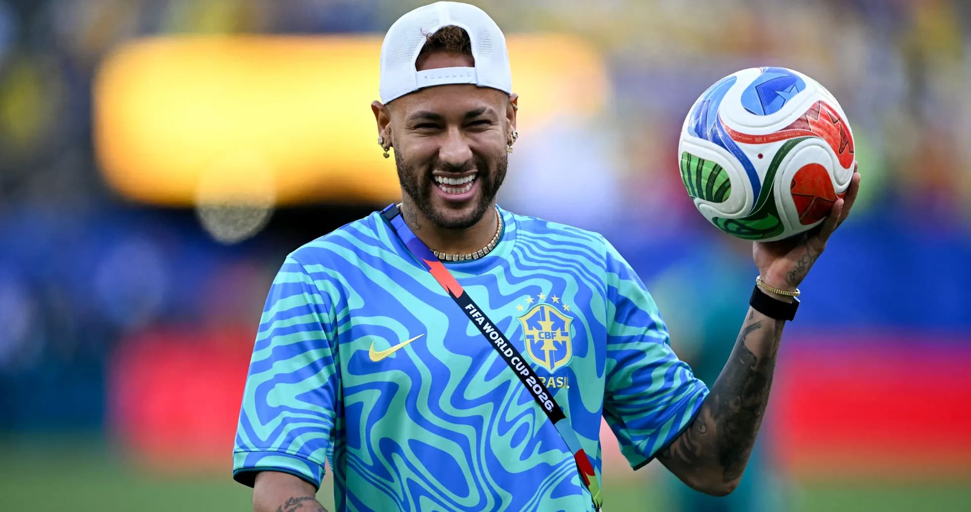 Player holding a soccer ball in warm-up attire Player holding a soccer ball in warm-up attire