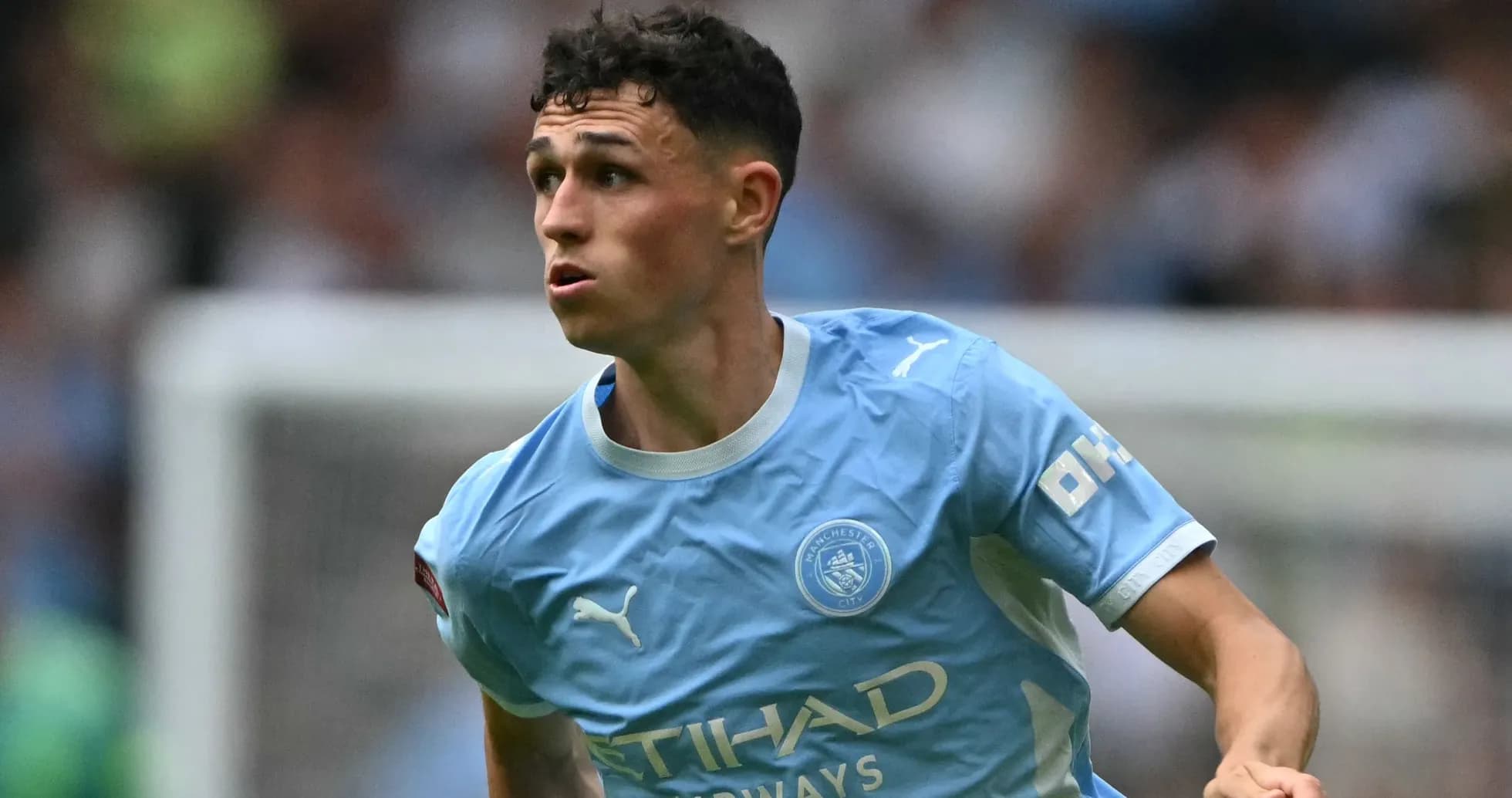 Player running during a Manchester City match Player running during a Manchester City match