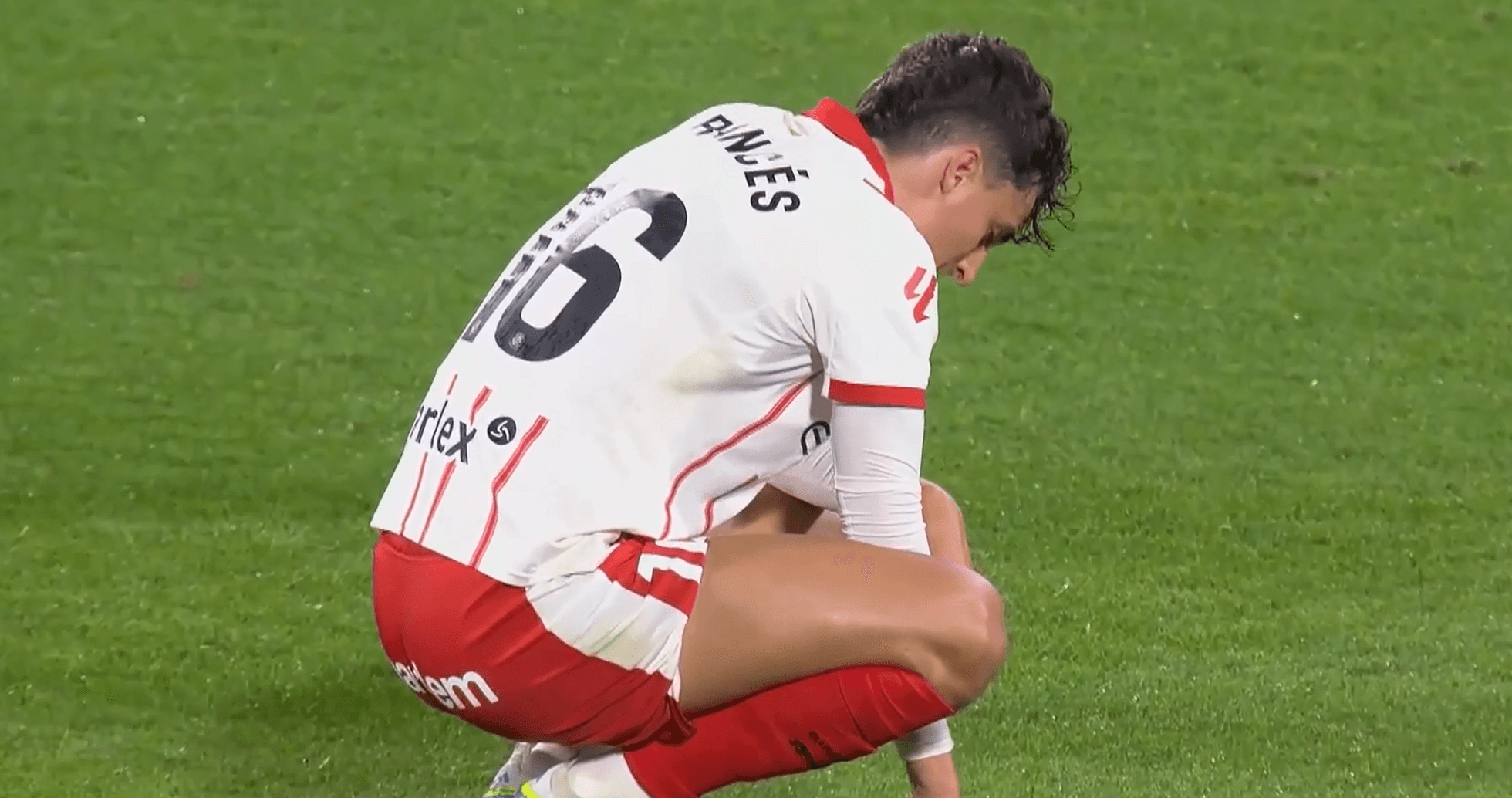 Girona player kneeling on the pitch during match Girona player kneeling on the pitch during match