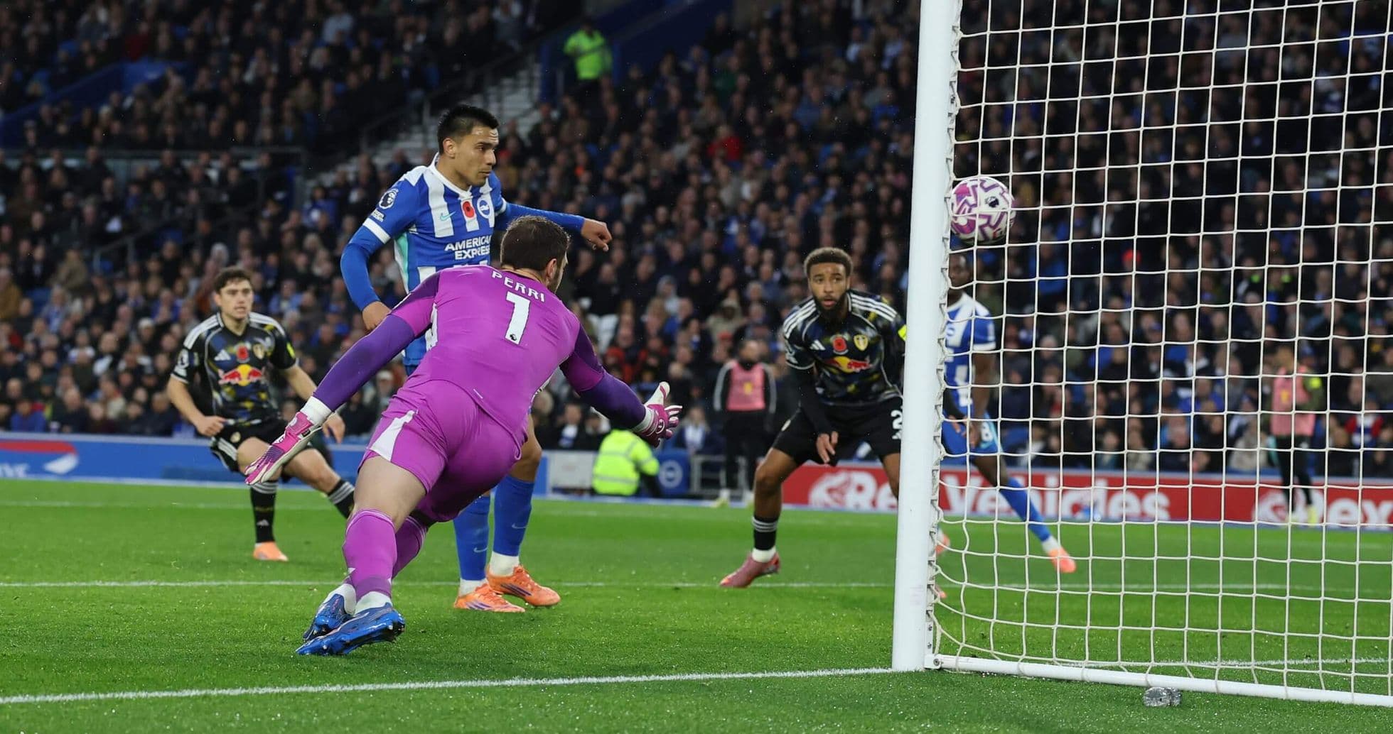 Brighton player scoring against Leeds goalkeeper Brighton player scoring against Leeds goalkeeper