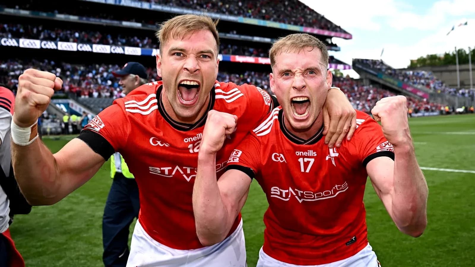 Two players celebrating in red jerseys after match Two players celebrating in red jerseys after match