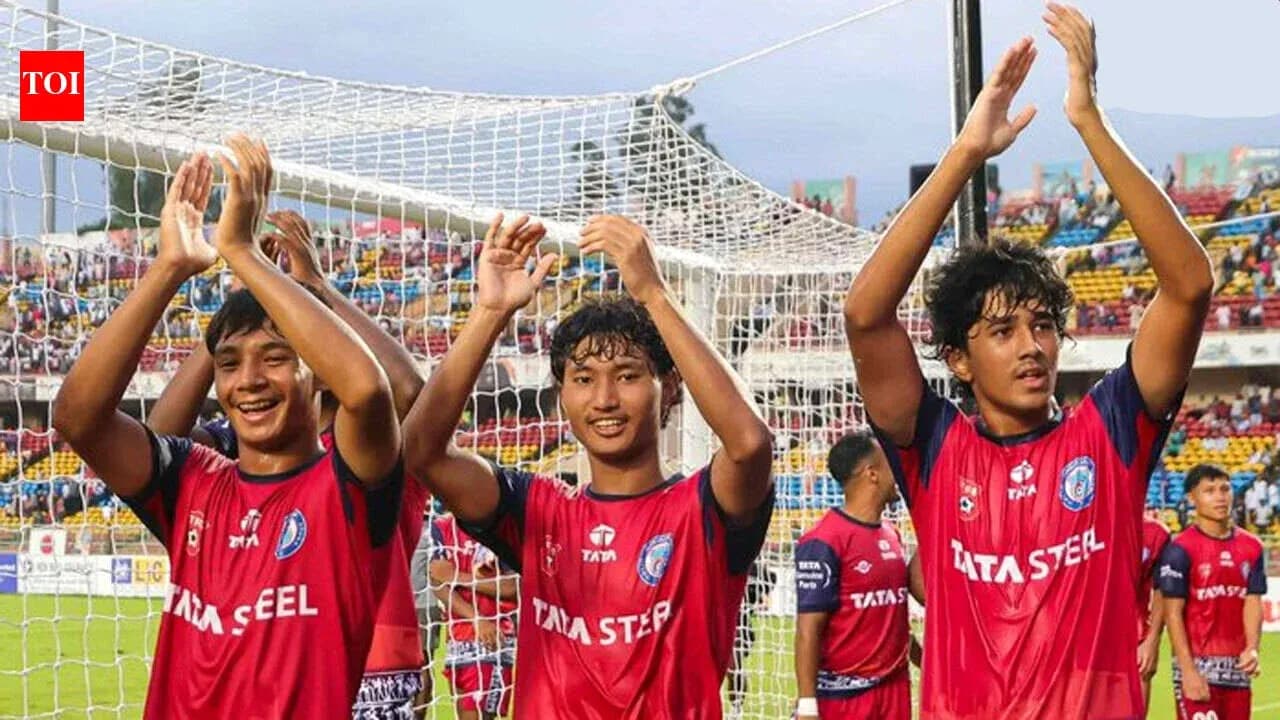 Three players celebrating in front of goal net Three players celebrating in front of goal net