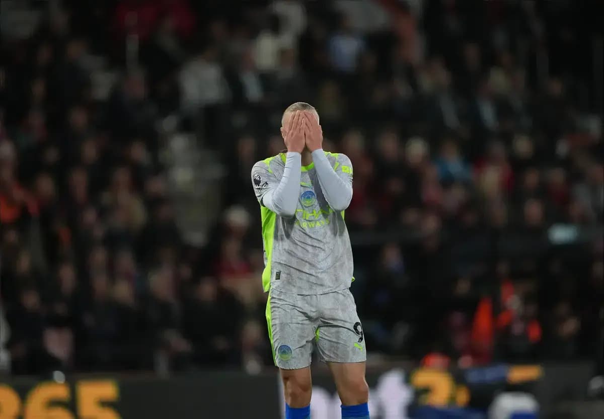 Goalkeeper covering face during intense match moment Goalkeeper covering face during intense match moment