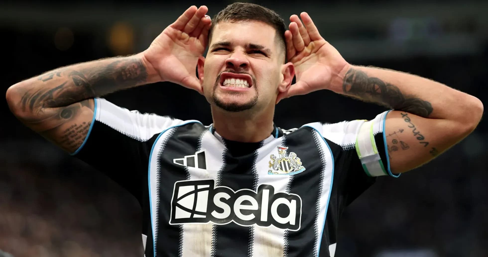 Player celebrating with hands on ears in stadium Player celebrating with hands on ears in stadium