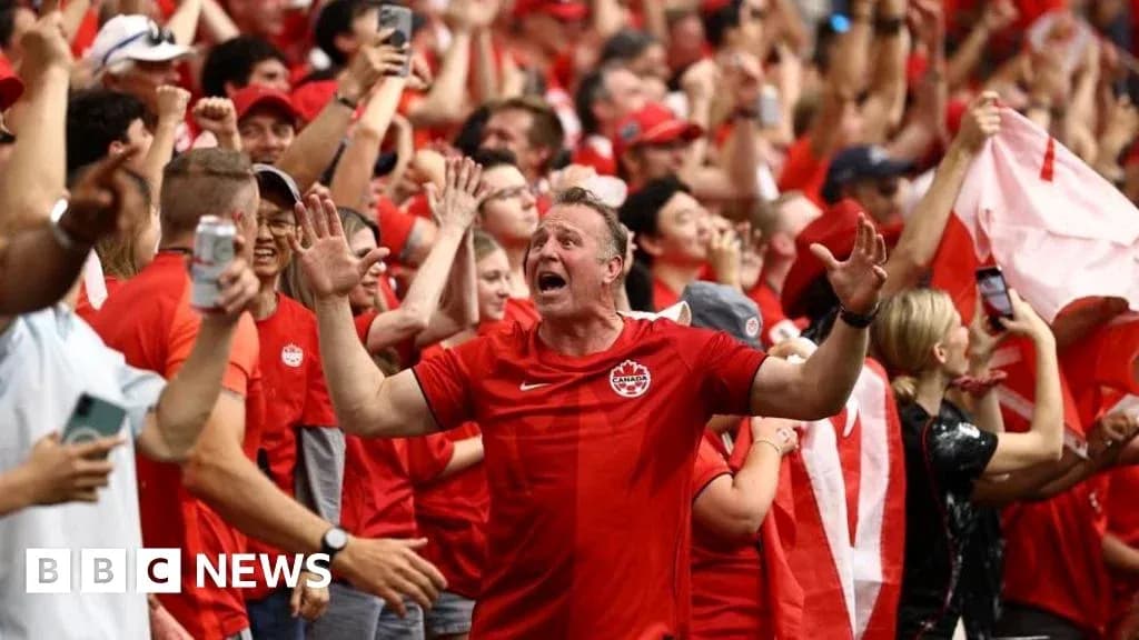 Fans celebrating in red at a sporting event Fans celebrating in red at a sporting event