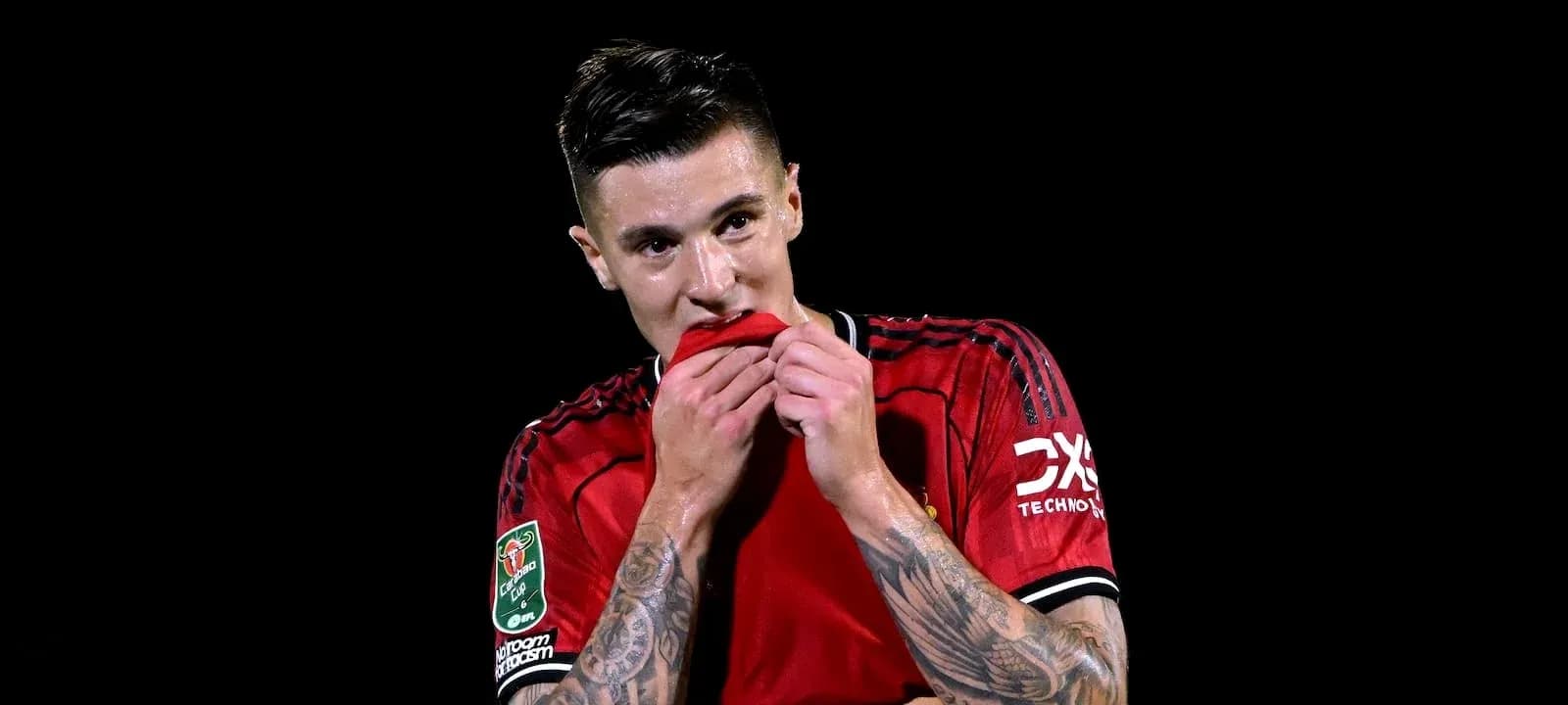 Player in red jersey holding shirt to mouth Player in red jersey holding shirt to mouth