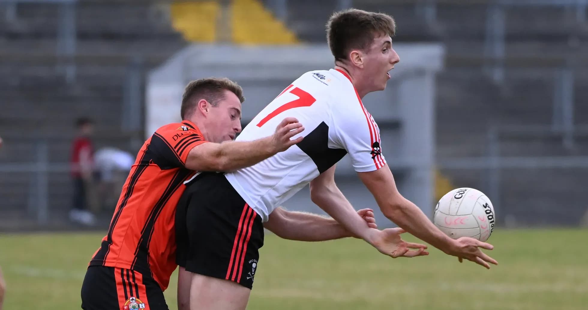 Two players competing for a football during match Two players competing for a football during match