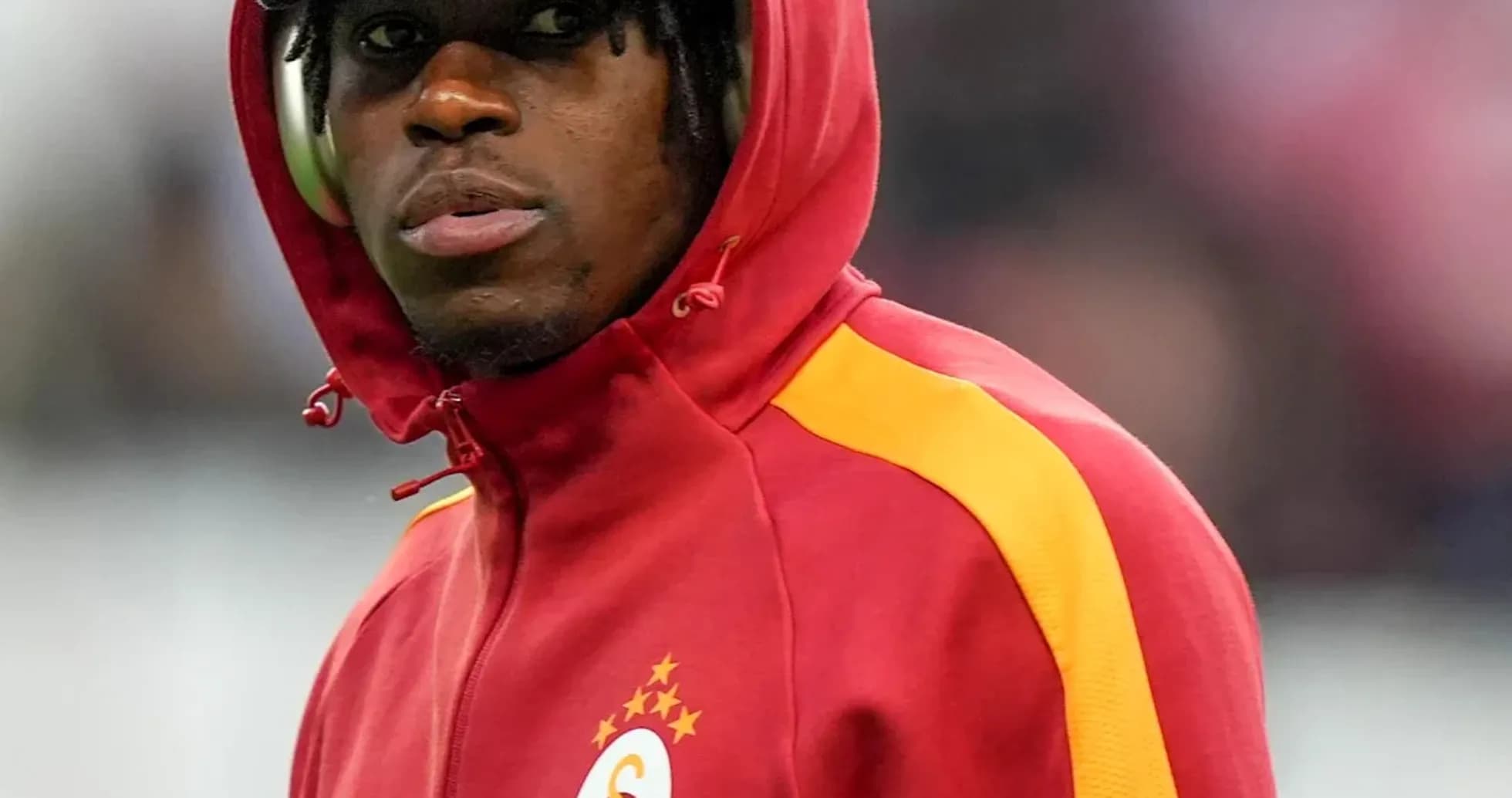 Player wearing red hoodie with club logo Player wearing red hoodie with club logo