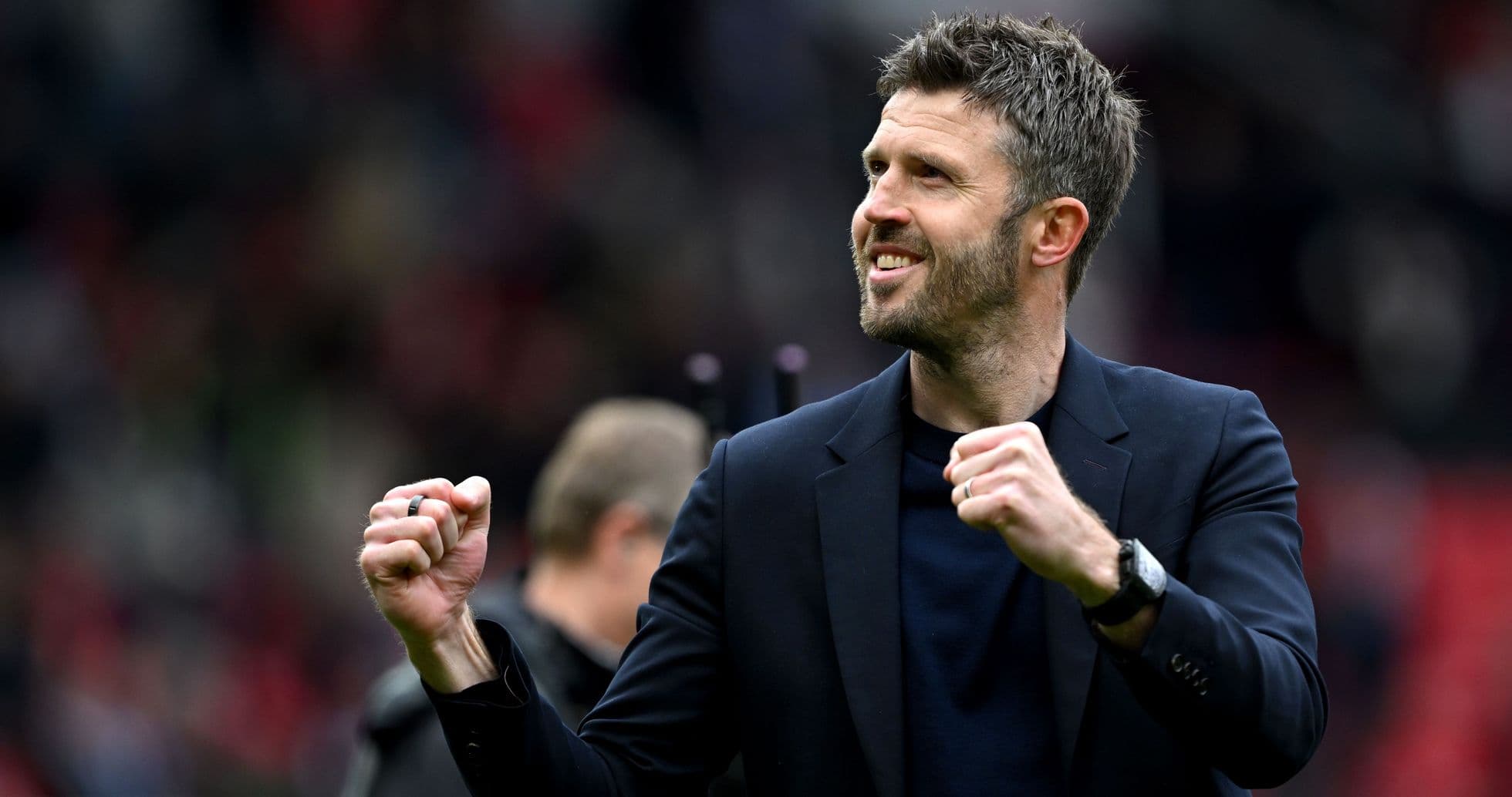 Manager celebrating with clenched fist on pitch Manager celebrating with clenched fist on pitch