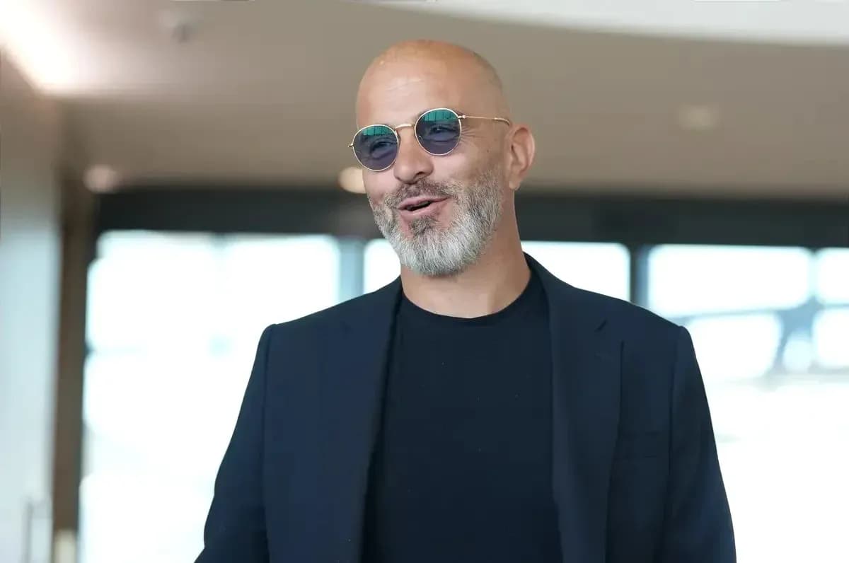 Man wearing sunglasses and a dark suit smiling Man wearing sunglasses and a dark suit smiling
