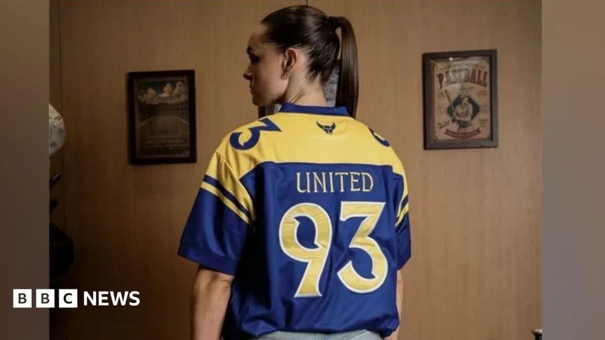 Person wearing a blue and yellow sports jersey Person wearing a blue and yellow sports jersey