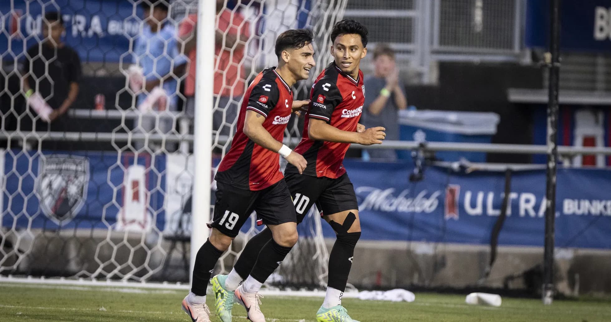 Players celebrating a goal during match Players celebrating a goal during match