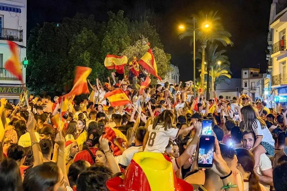 Crowd celebrating with flags in a street at night Crowd celebrating with flags in a street at night
