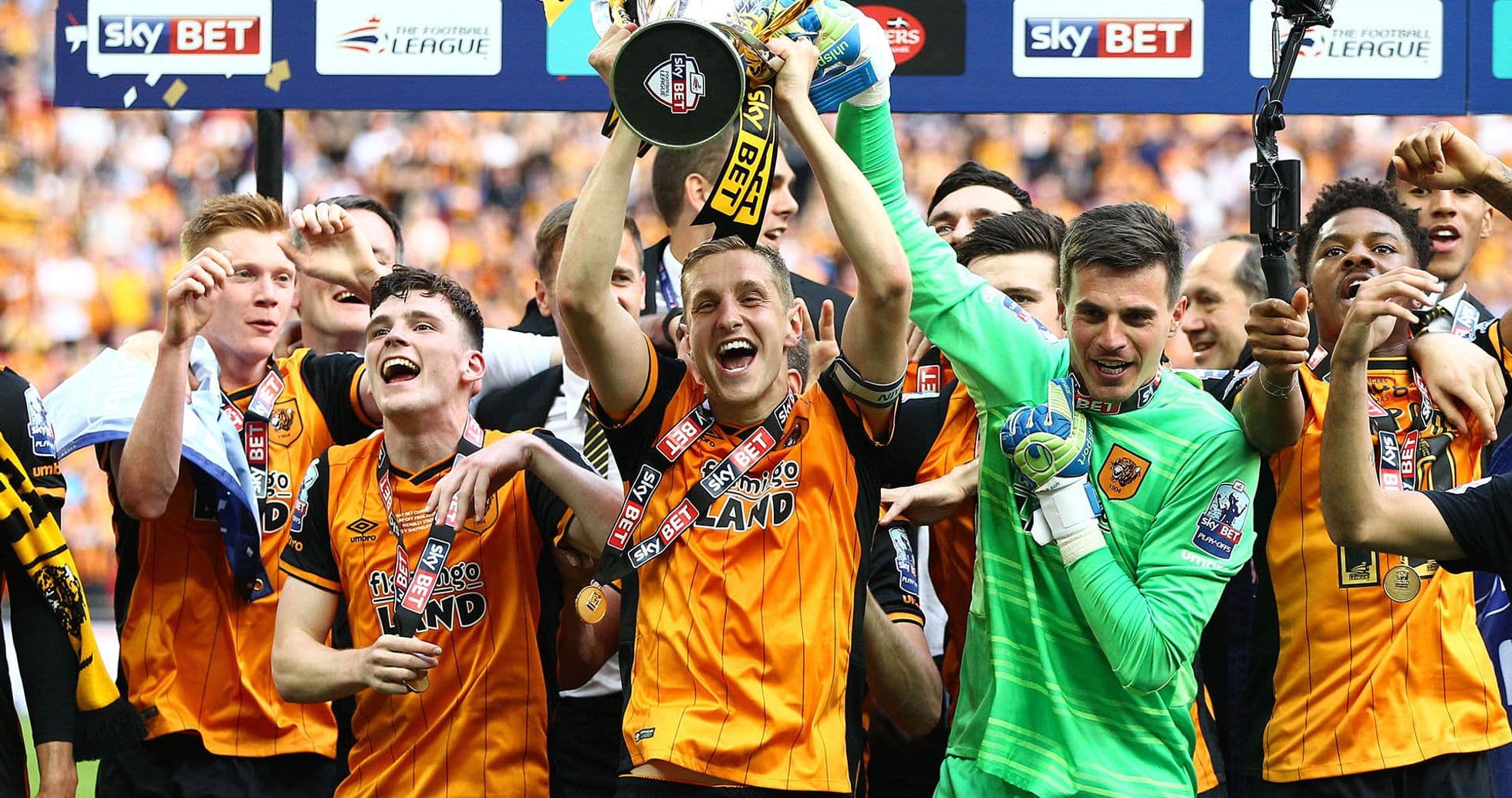 Team celebrating with trophy after championship victory Team celebrating with trophy after championship victory