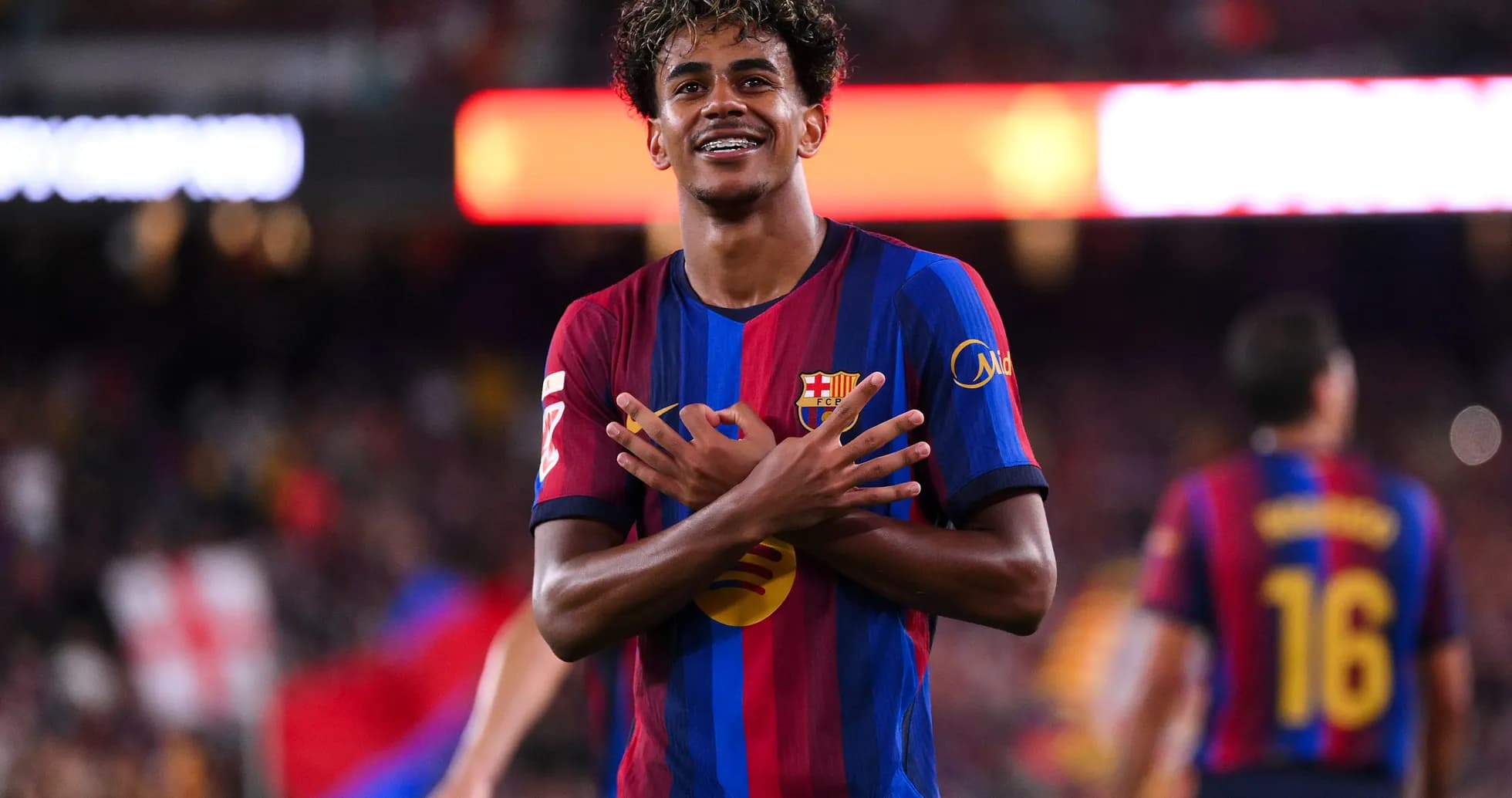 Player celebrating with arms crossed on the field Player celebrating with arms crossed on the field