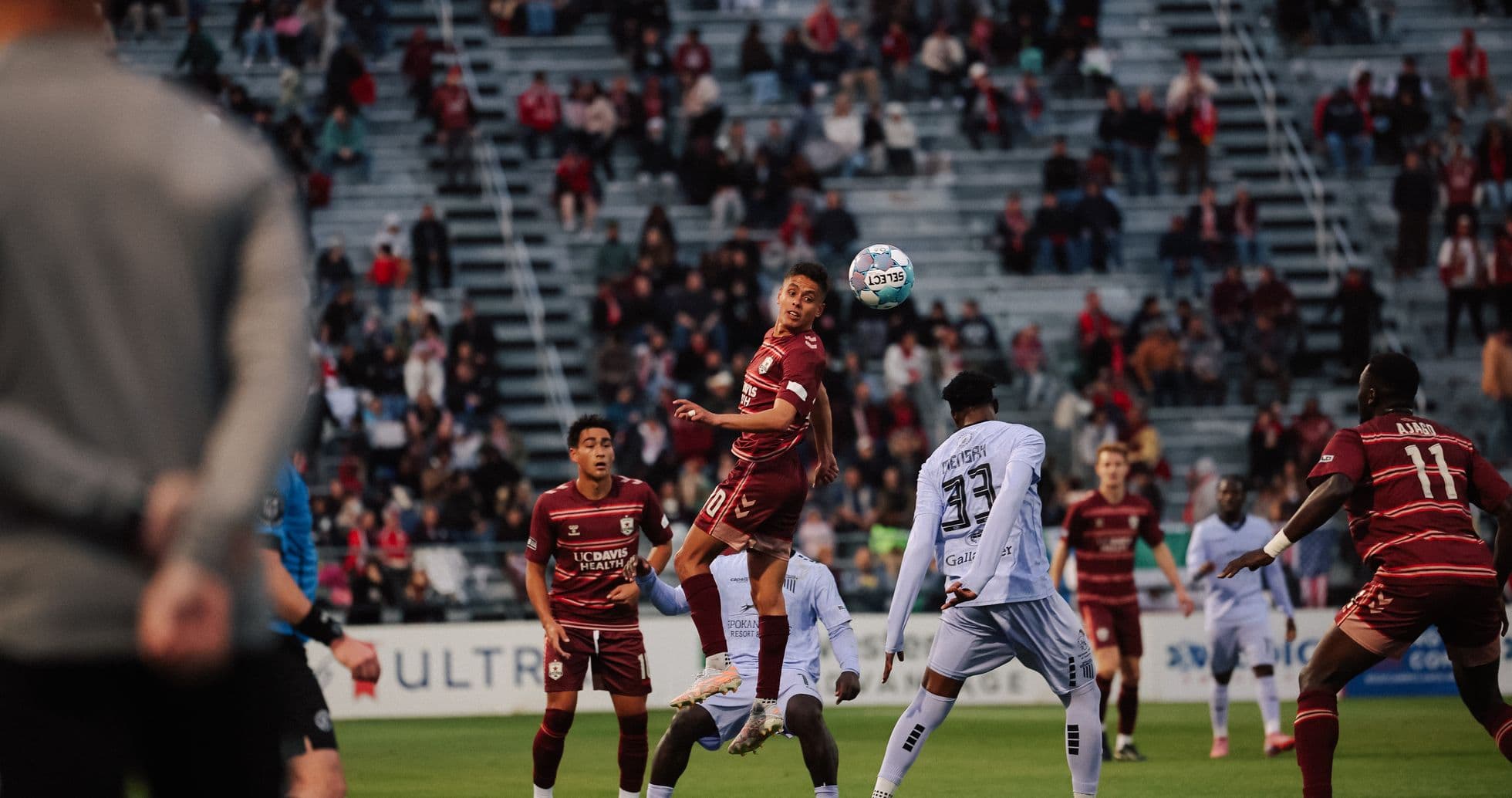 Players contesting a high ball during match Players contesting a high ball during match