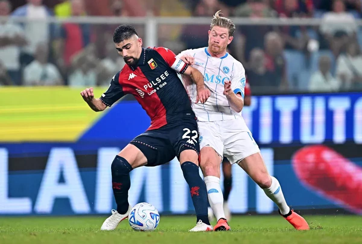 Genoa player tackled by Napoli opponent during match Genoa player tackled by Napoli opponent during match