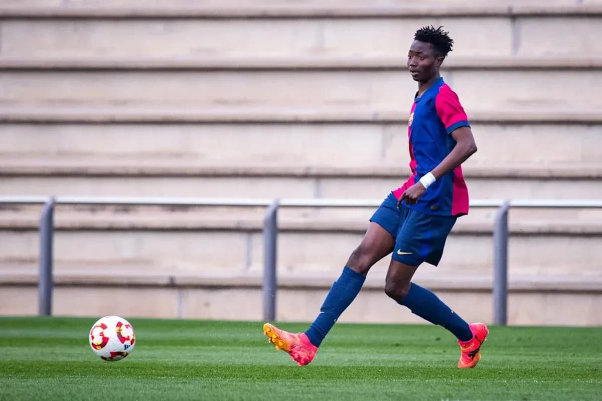 Player in Barcelona kit passing ball on field Player in Barcelona kit passing ball on field