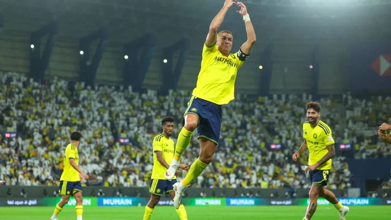 Player celebrating during match with teammates in stadium Player celebrating during match with teammates in stadium