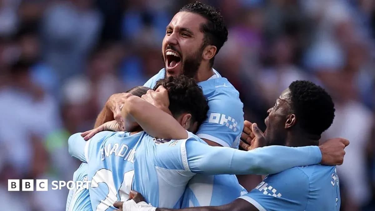 Players celebrating a goal in Manchester City kit Players celebrating a goal in Manchester City kit