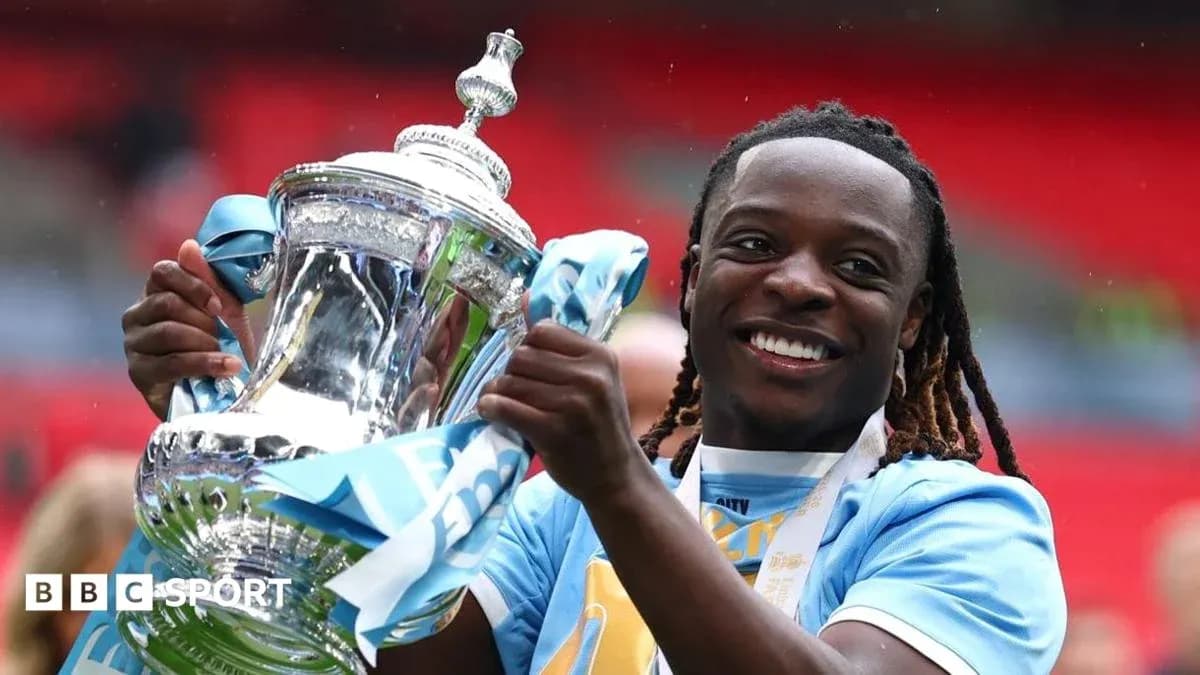Player celebrating with trophy at stadium Player celebrating with trophy at stadium