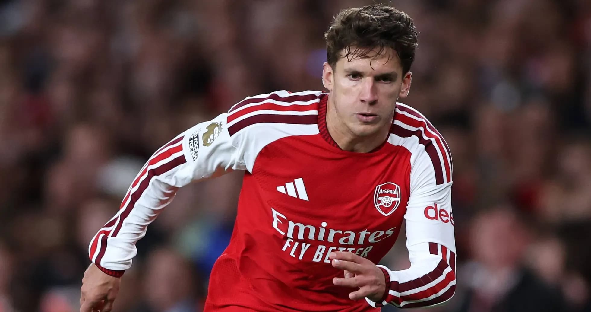 Player sprinting in Arsenal's red home kit Player sprinting in Arsenal's red home kit
