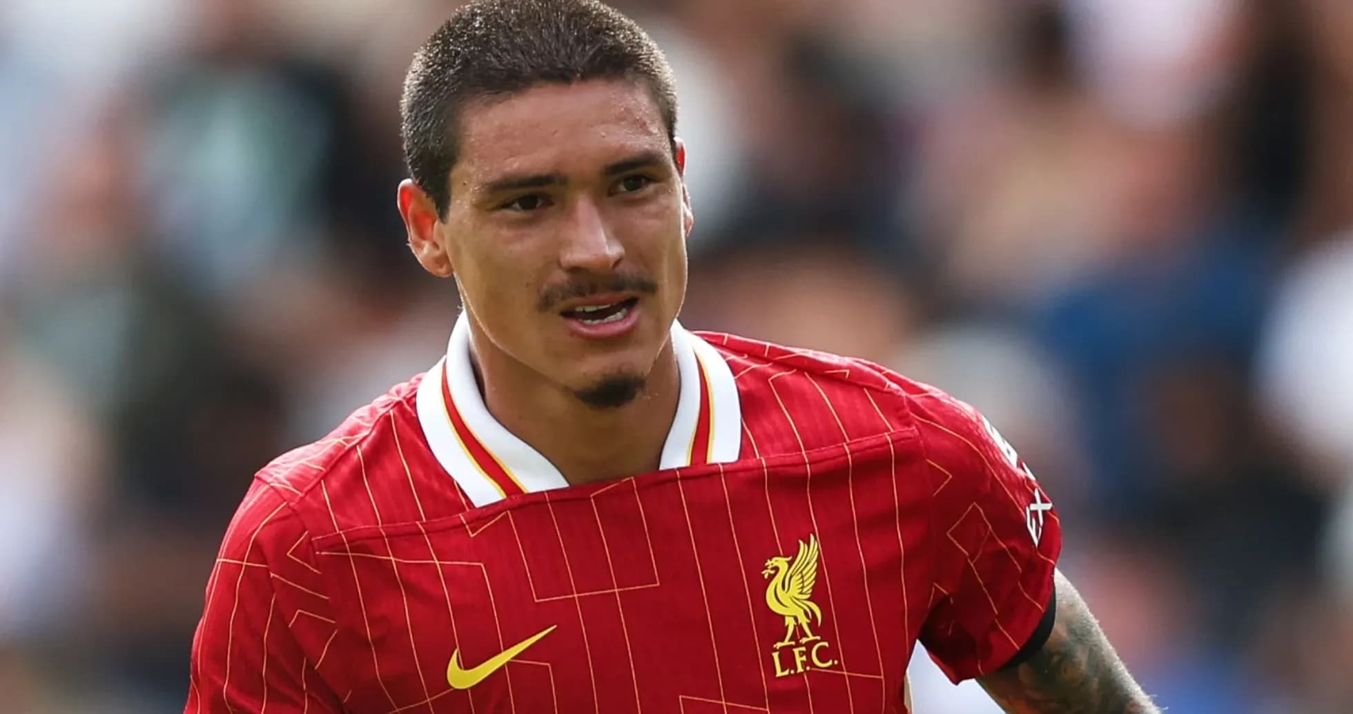 Player in Liverpool jersey during match action Player in Liverpool jersey during match action