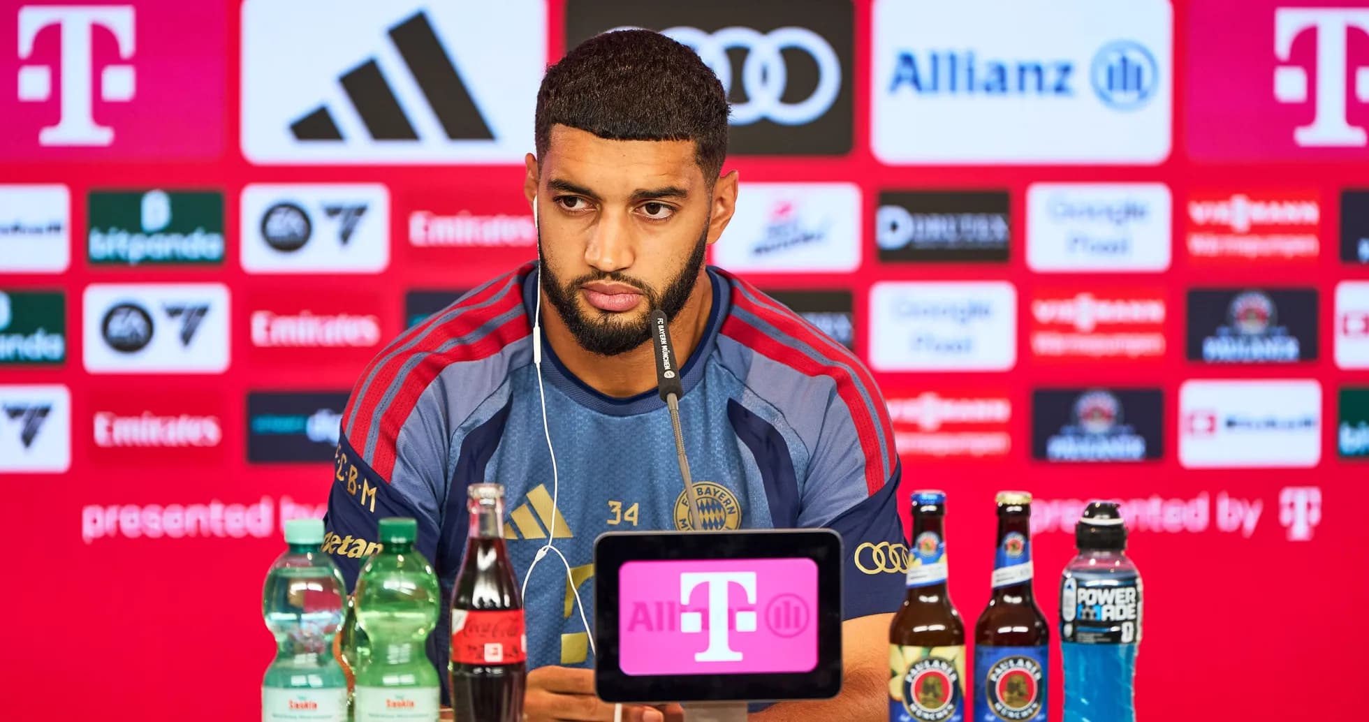 Player at press conference with drinks on table Player at press conference with drinks on table