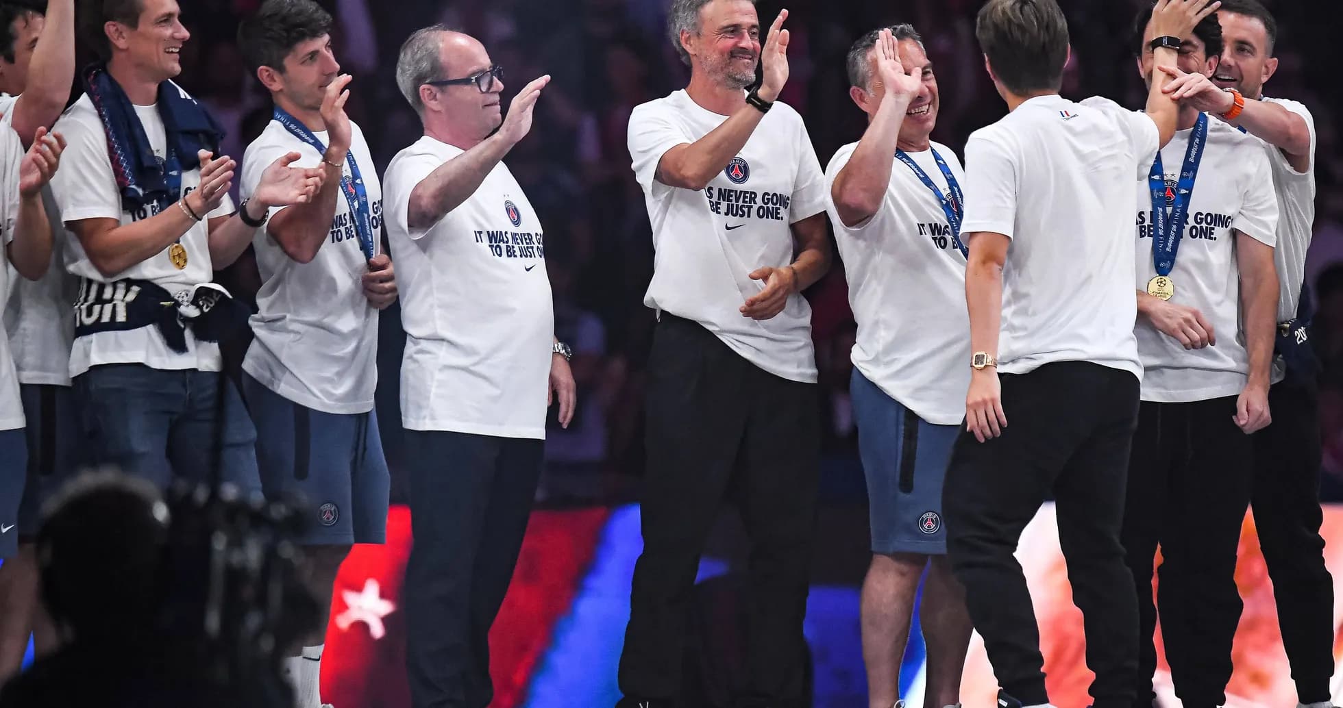 Coaches celebrating with team during victory ceremony Coaches celebrating with team during victory ceremony