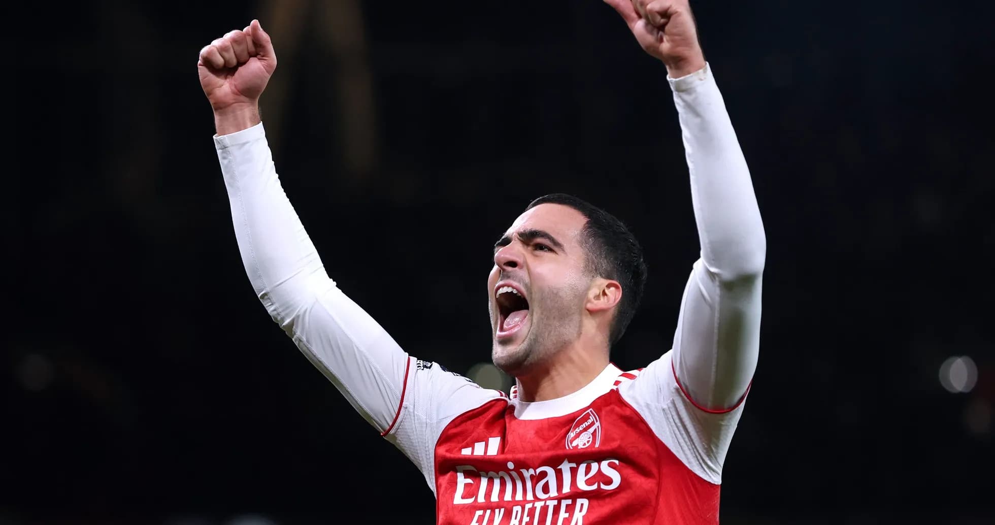 Player celebrating with raised fists in Arsenal jersey Player celebrating with raised fists in Arsenal jersey