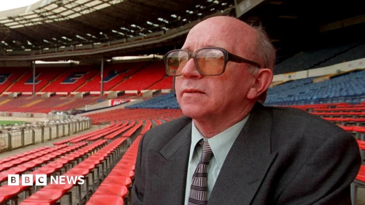 Man in glasses sitting in empty stadium seats Man in glasses sitting in empty stadium seats