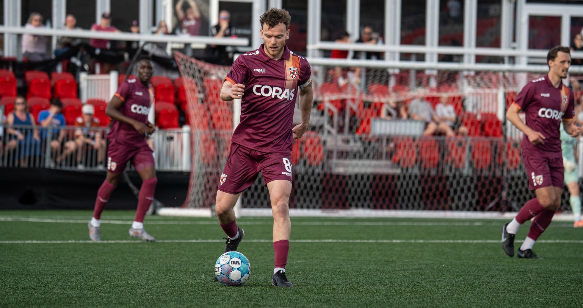 Player dribbling ball during football match Player dribbling ball during football match