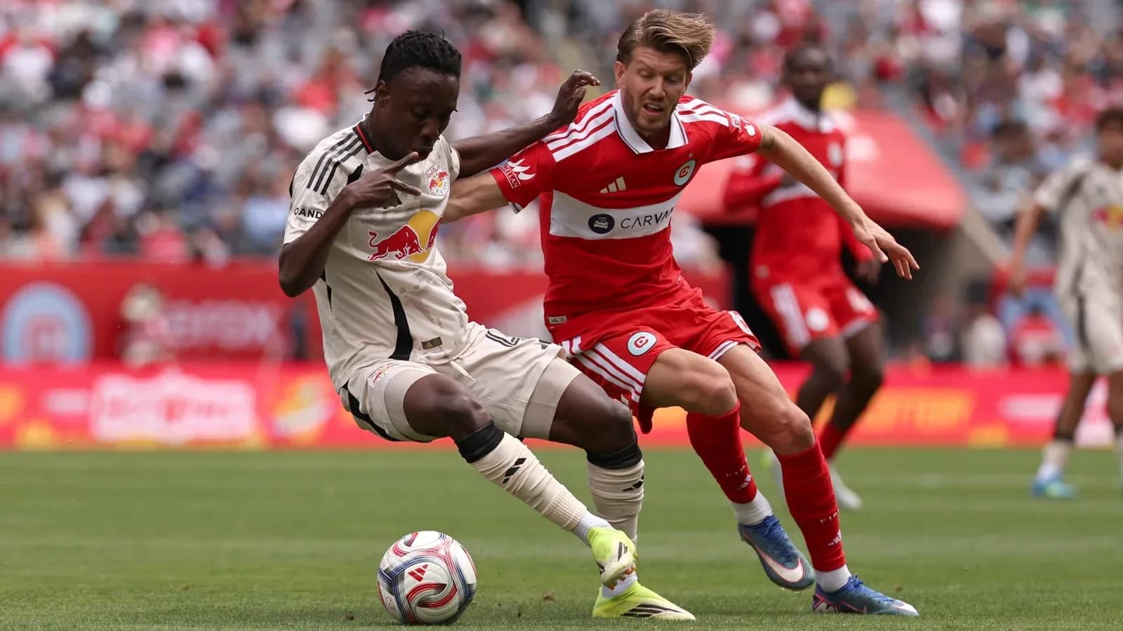 New York Red Bulls player challenging Chicago Fire opponent New York Red Bulls player challenging Chicago Fire opponent