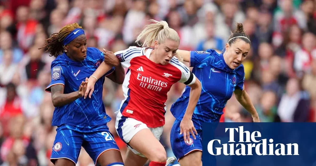 Player in red being challenged by two defenders Player in red being challenged by two defenders
