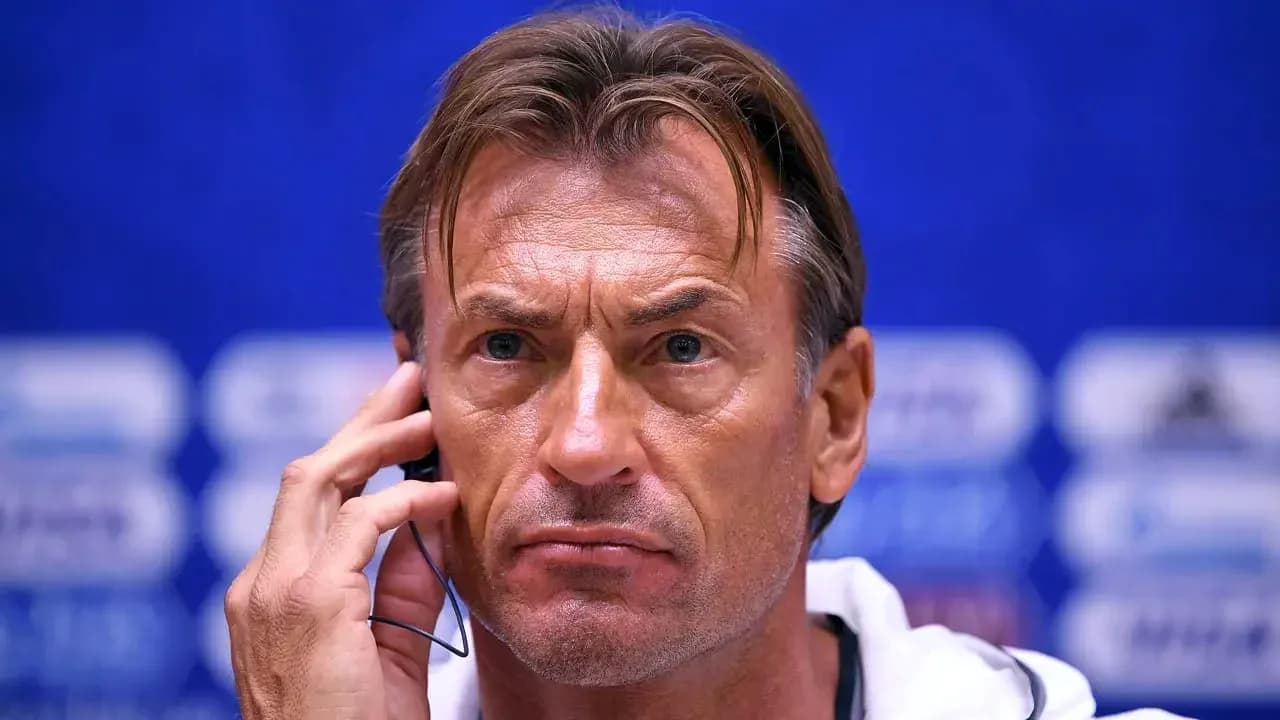 Coach at press conference with earpiece in ear Coach at press conference with earpiece in ear