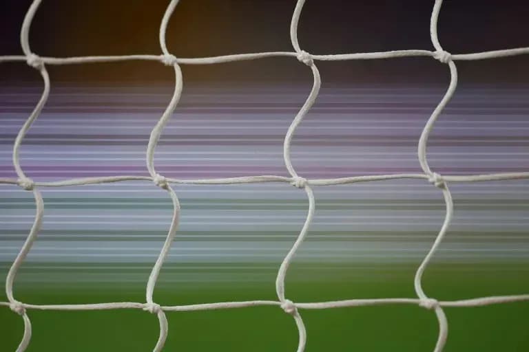 Close-up of football goal net with blurred background Close-up of football goal net with blurred background