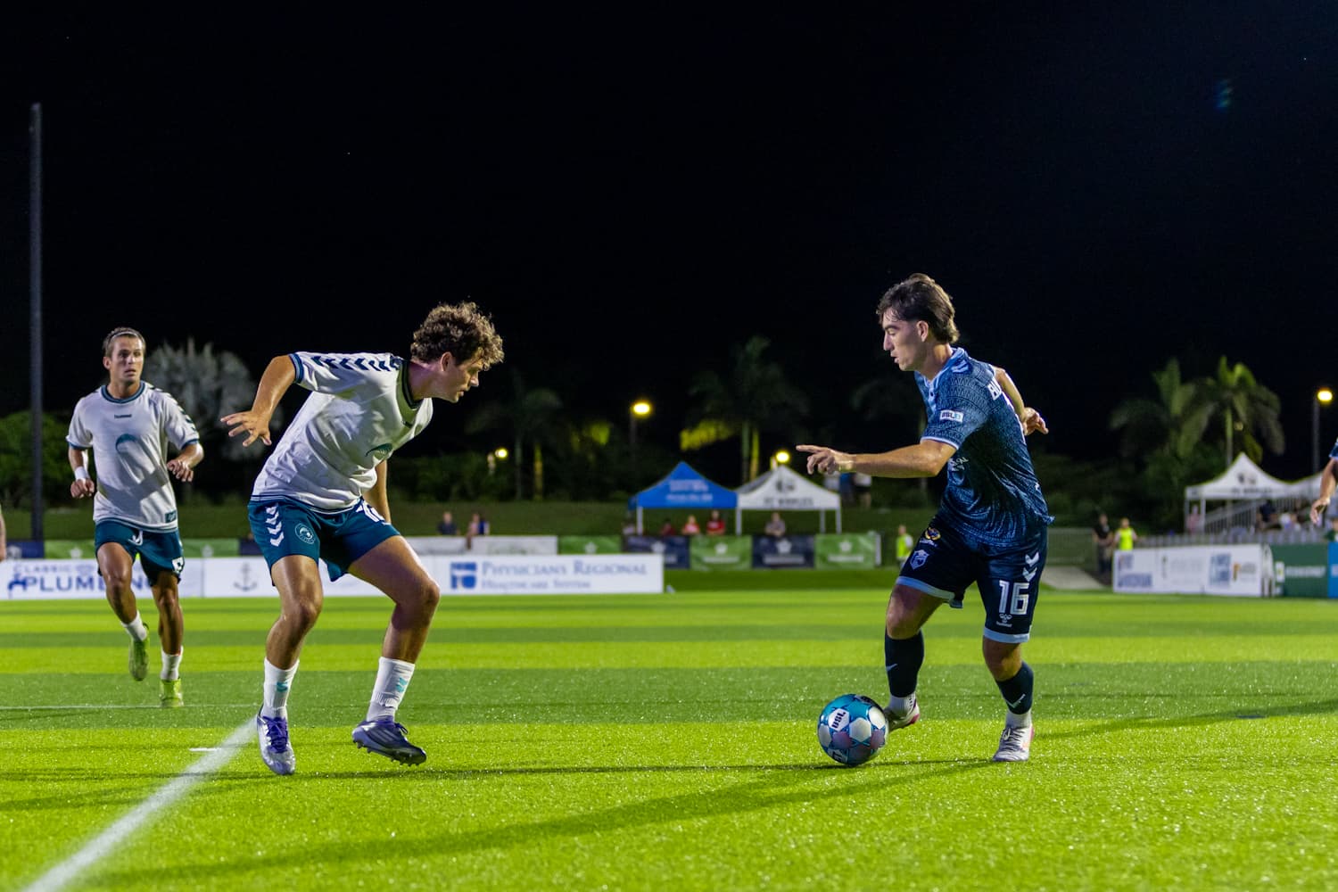 Players competing for the ball in USL match Players competing for the ball in USL match