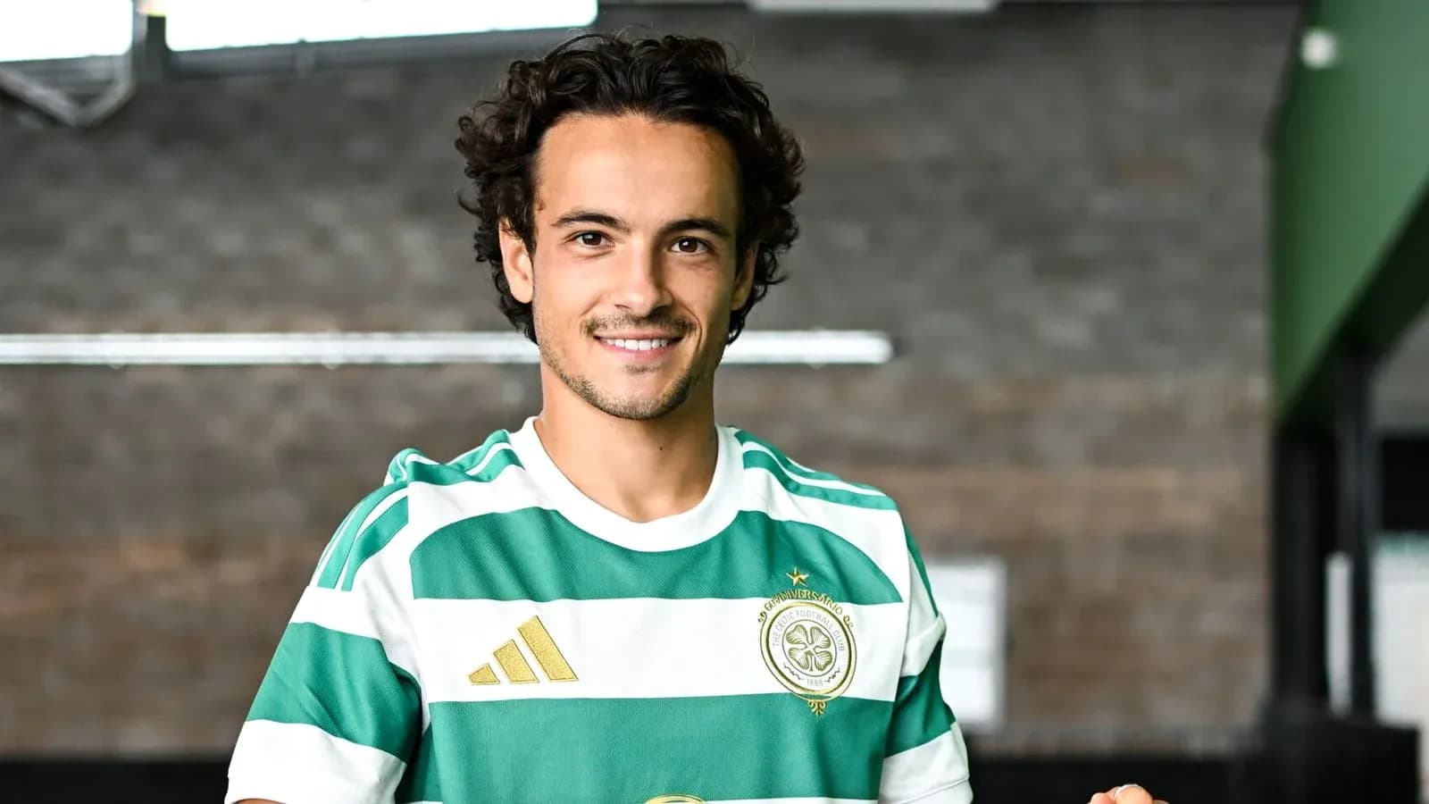 Player wearing Celtic FC kit and smiling Player wearing Celtic FC kit and smiling