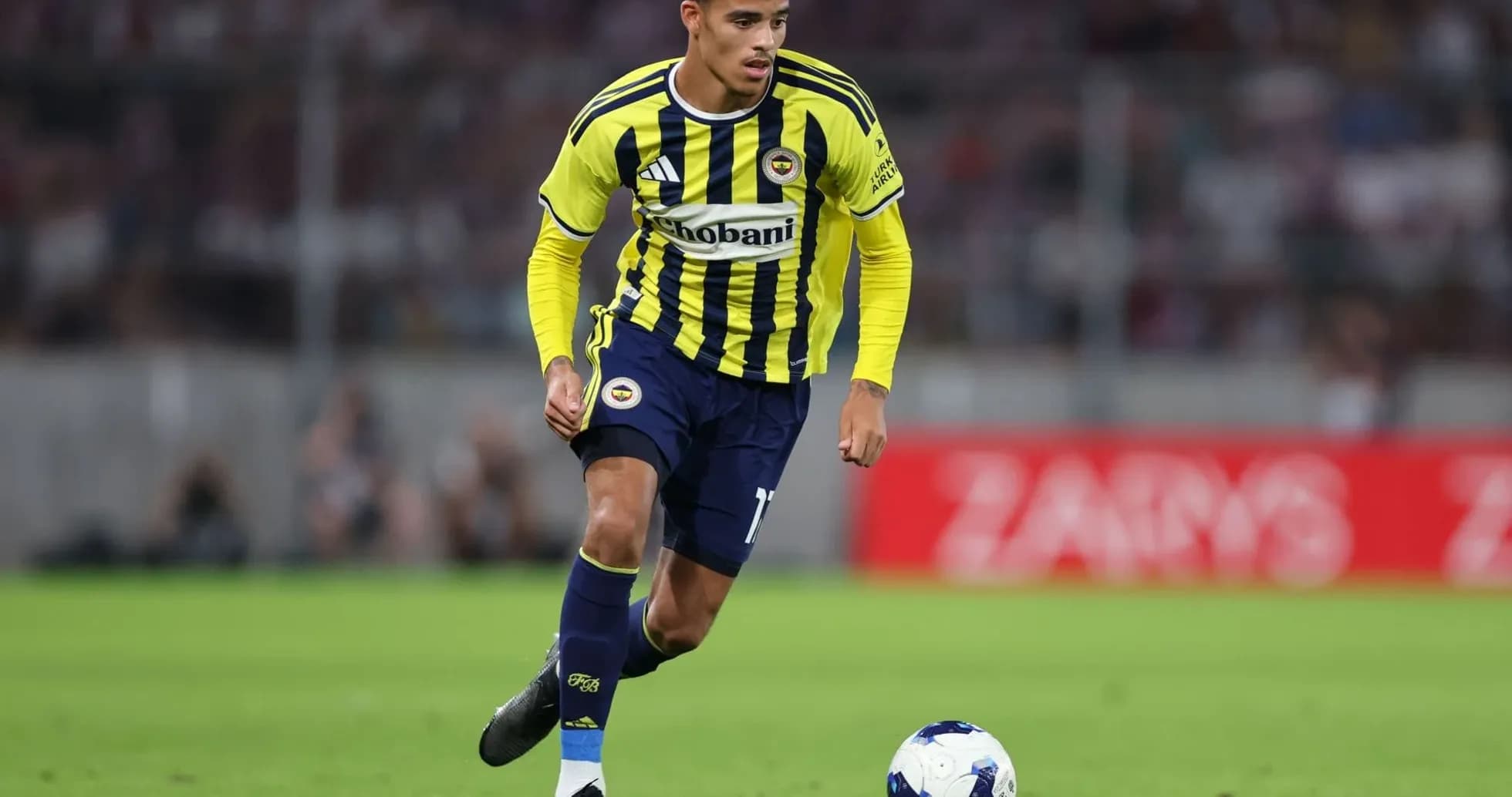 Fenerbahçe player dribbling during a match Fenerbahçe player dribbling during a match