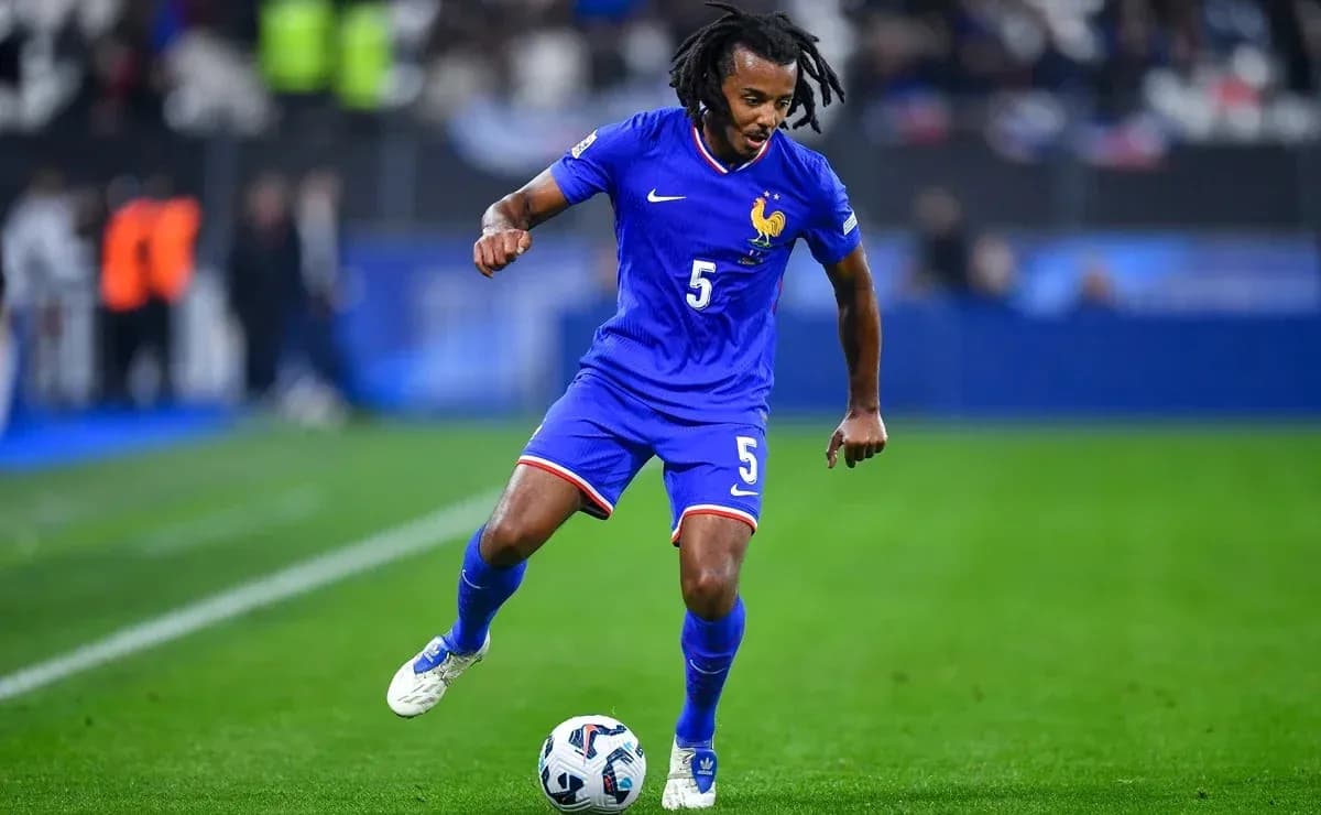 Player in blue kit dribbling ball on field Player in blue kit dribbling ball on field