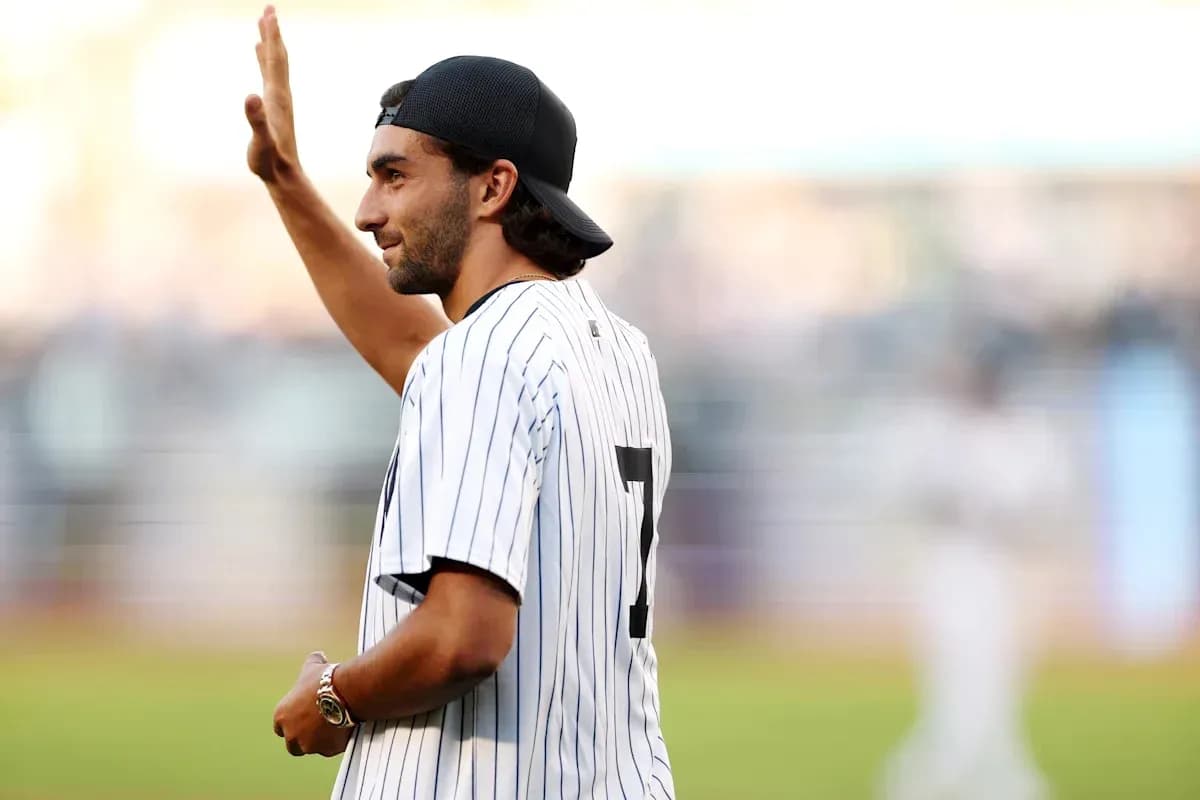 Man waving while wearing a pinstriped jersey Man waving while wearing a pinstriped jersey