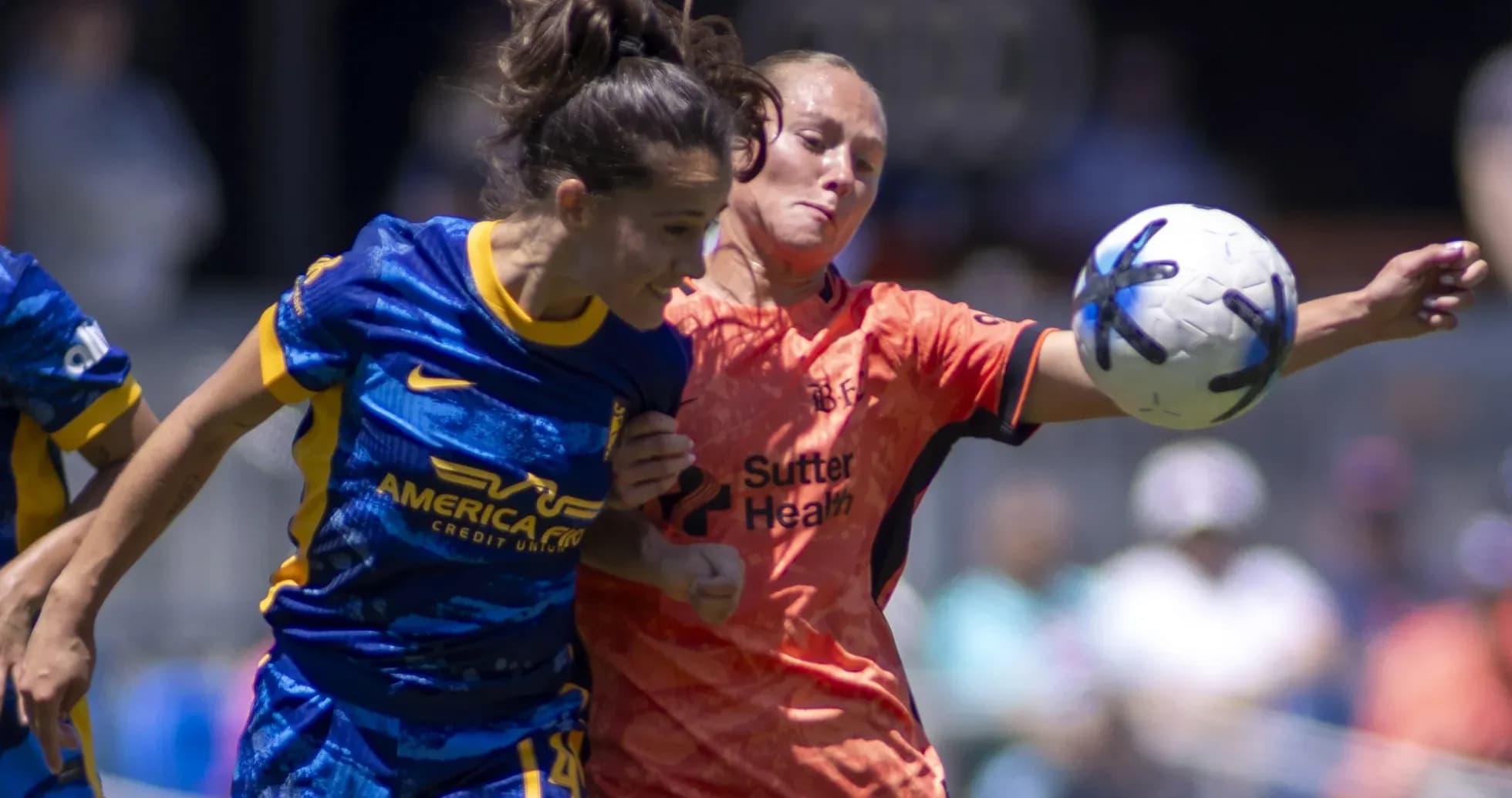 Two players competing for the ball in match Two players competing for the ball in match
