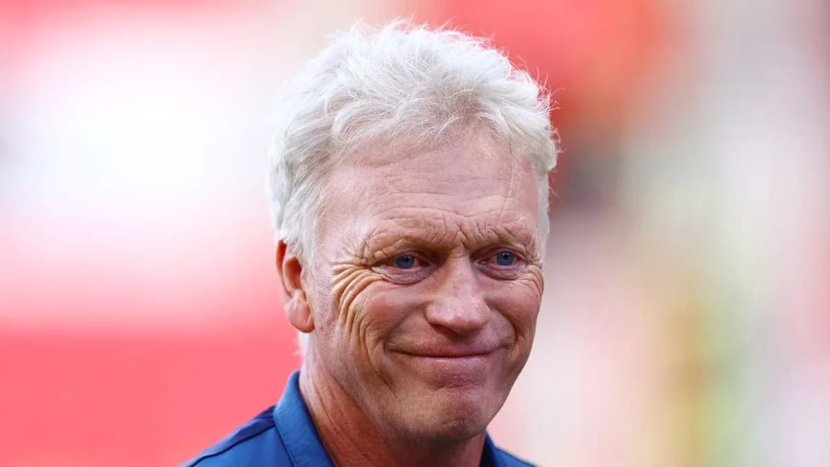 Football manager smiling during pre-match warm-up Football manager smiling during pre-match warm-up