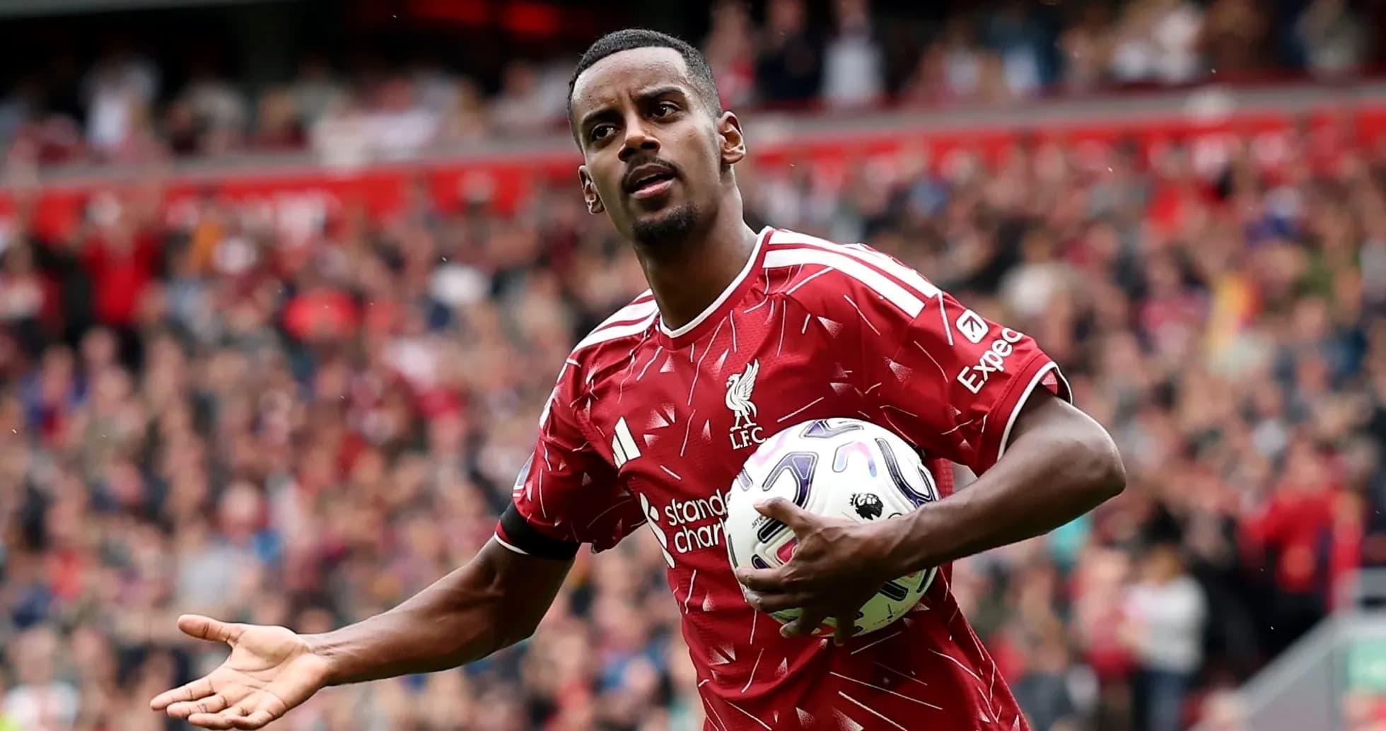 Player in Liverpool kit holding ball during match Player in Liverpool kit holding ball during match